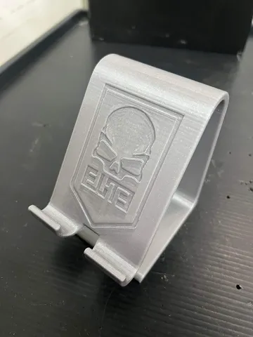 A smartphone stand with the COD ELITE logo