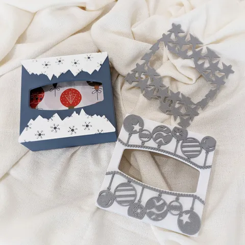 Napkin holder with interchangeable and customizeable decorations (christmas balls, stars, mountains with snow flakes...)