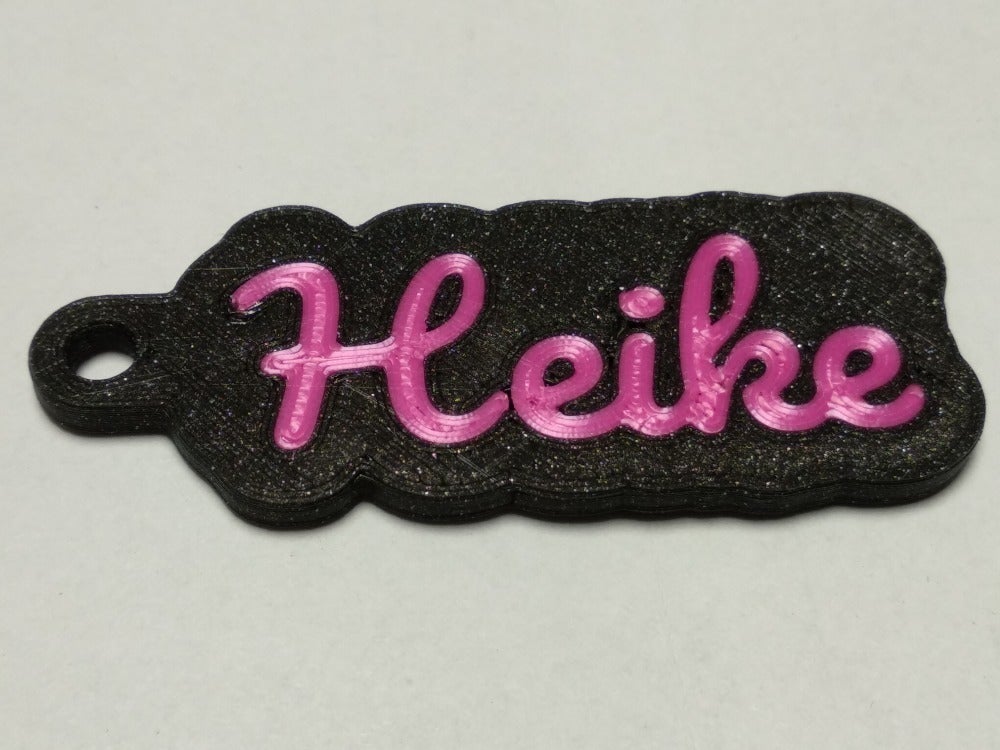 Double sided key chain for multi material printing with your name (OpenSCAD)