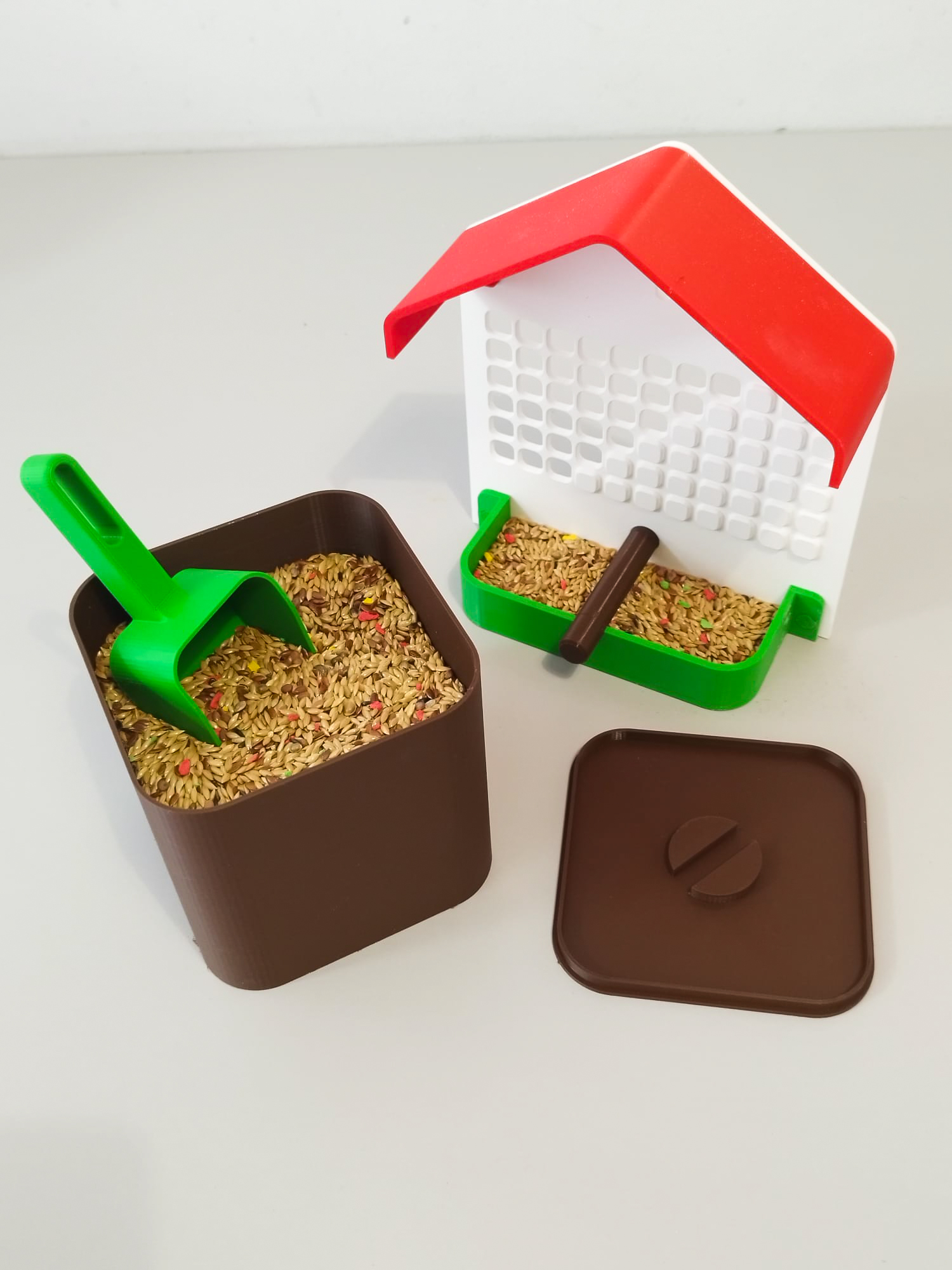 Bird feeder with storage and serving scoop