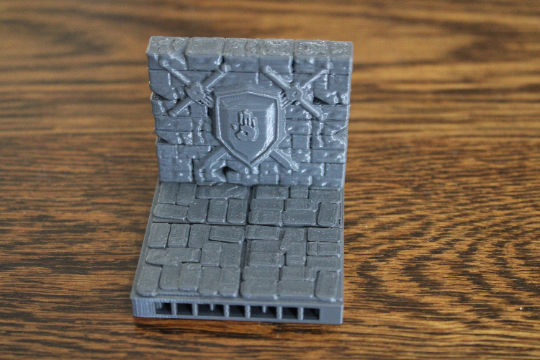 OpenLock Dungeon tile wall with decorative hanging sword and shield