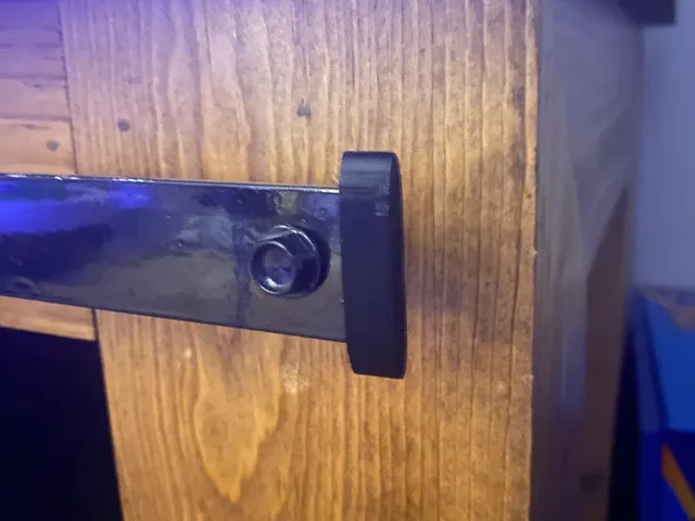 Sliding barn door rail end cap