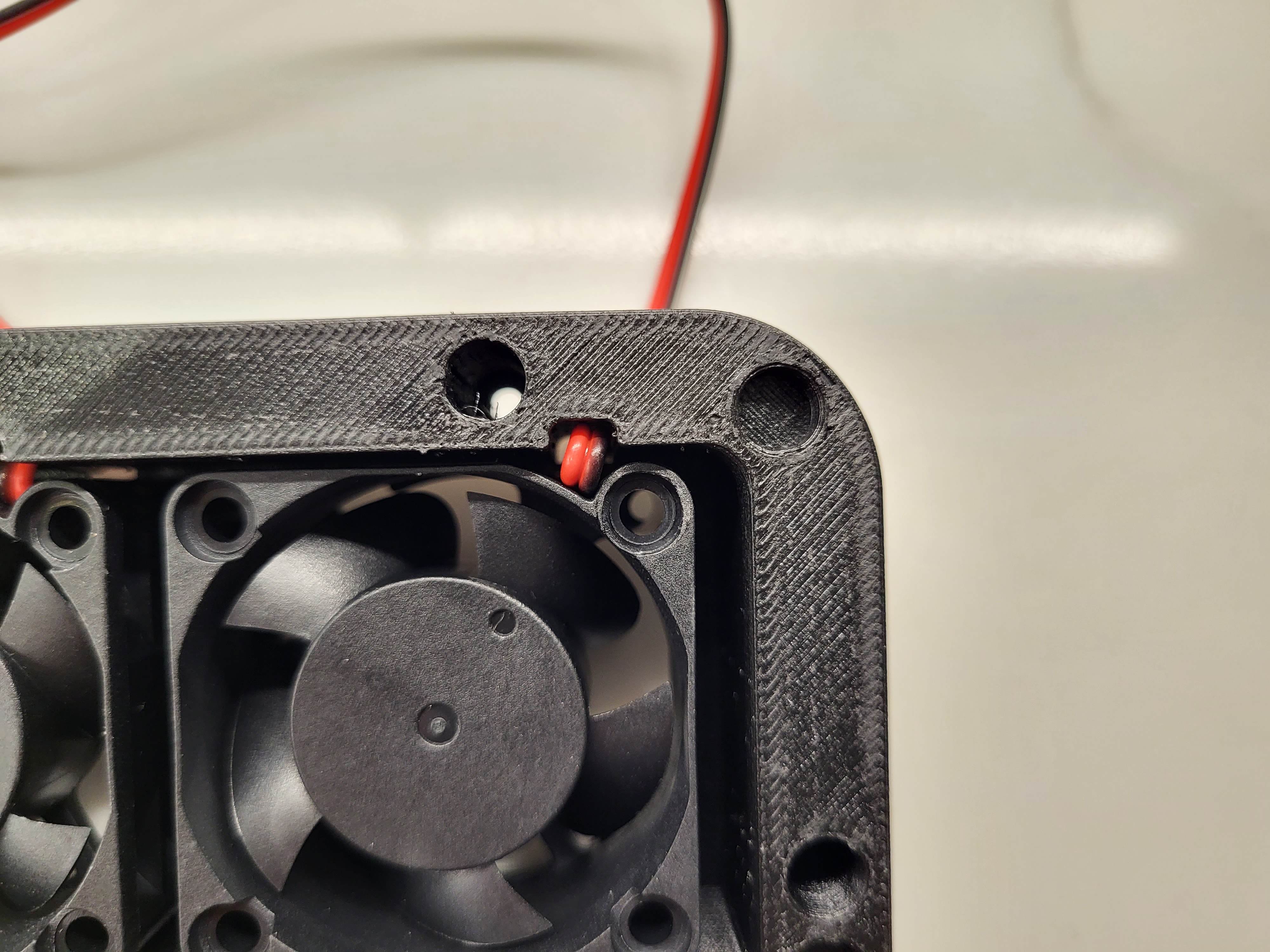 Bento Box fan bracket modified. Added wire strain relief