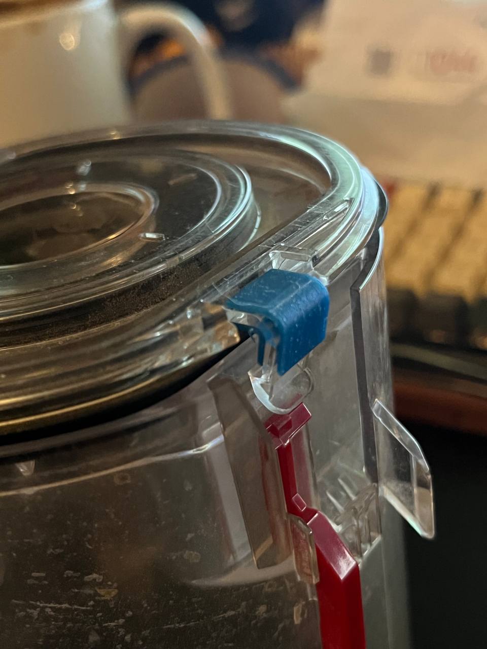3D printed Dyson SV03 dust container clip replacement installed on a handheld vacuum bin
