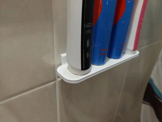 Electric toothbrush holder for attaching to the wall