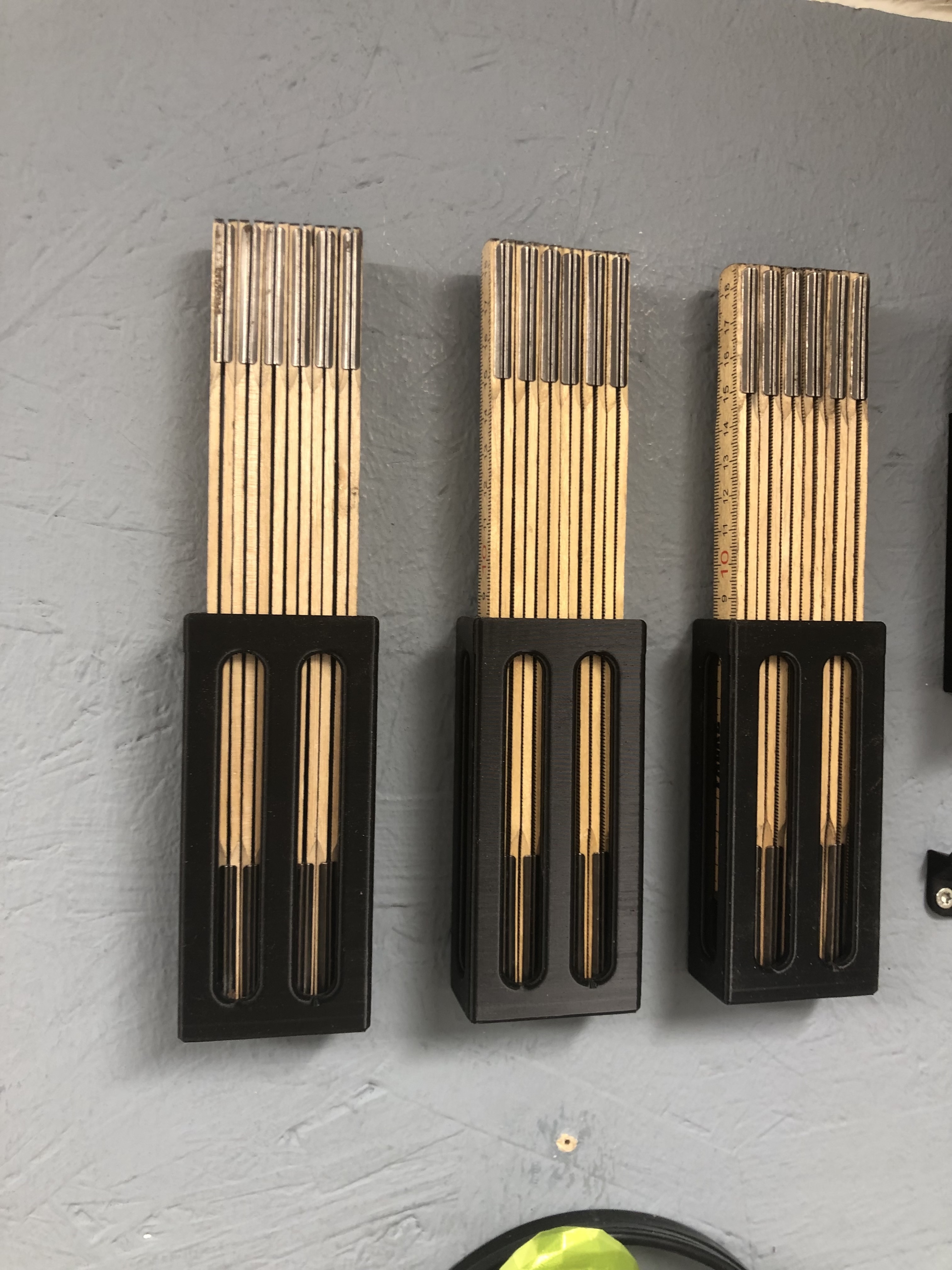 Wall holder for carpenters ruler
