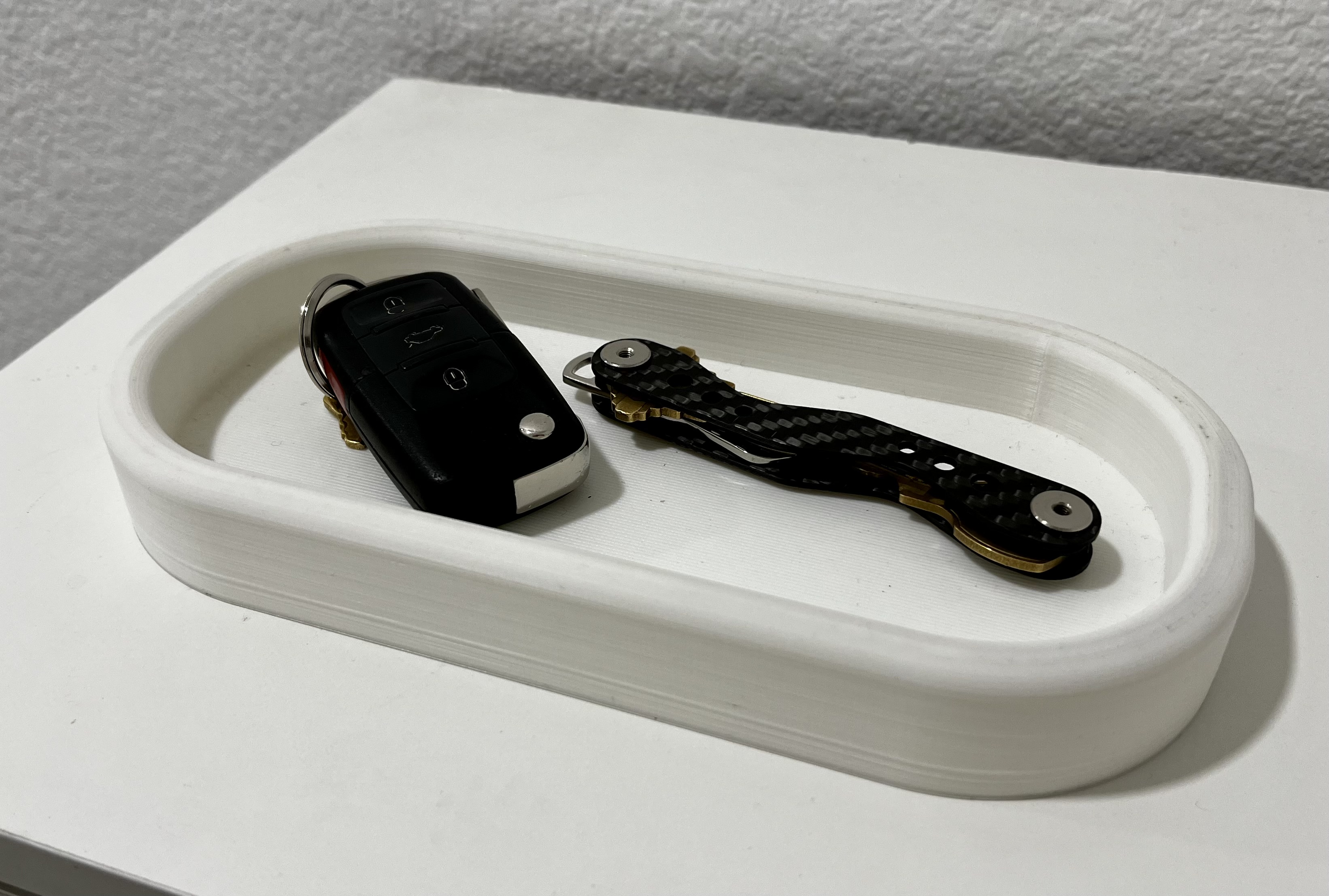 Pill shaped catch-all tray
