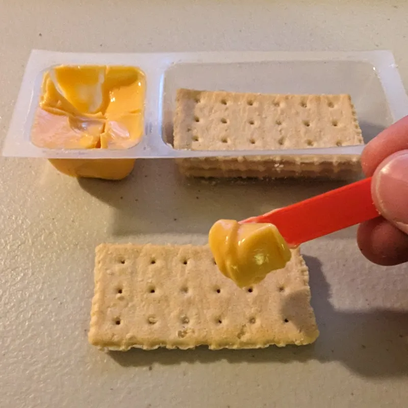 The snack with the little red stick
