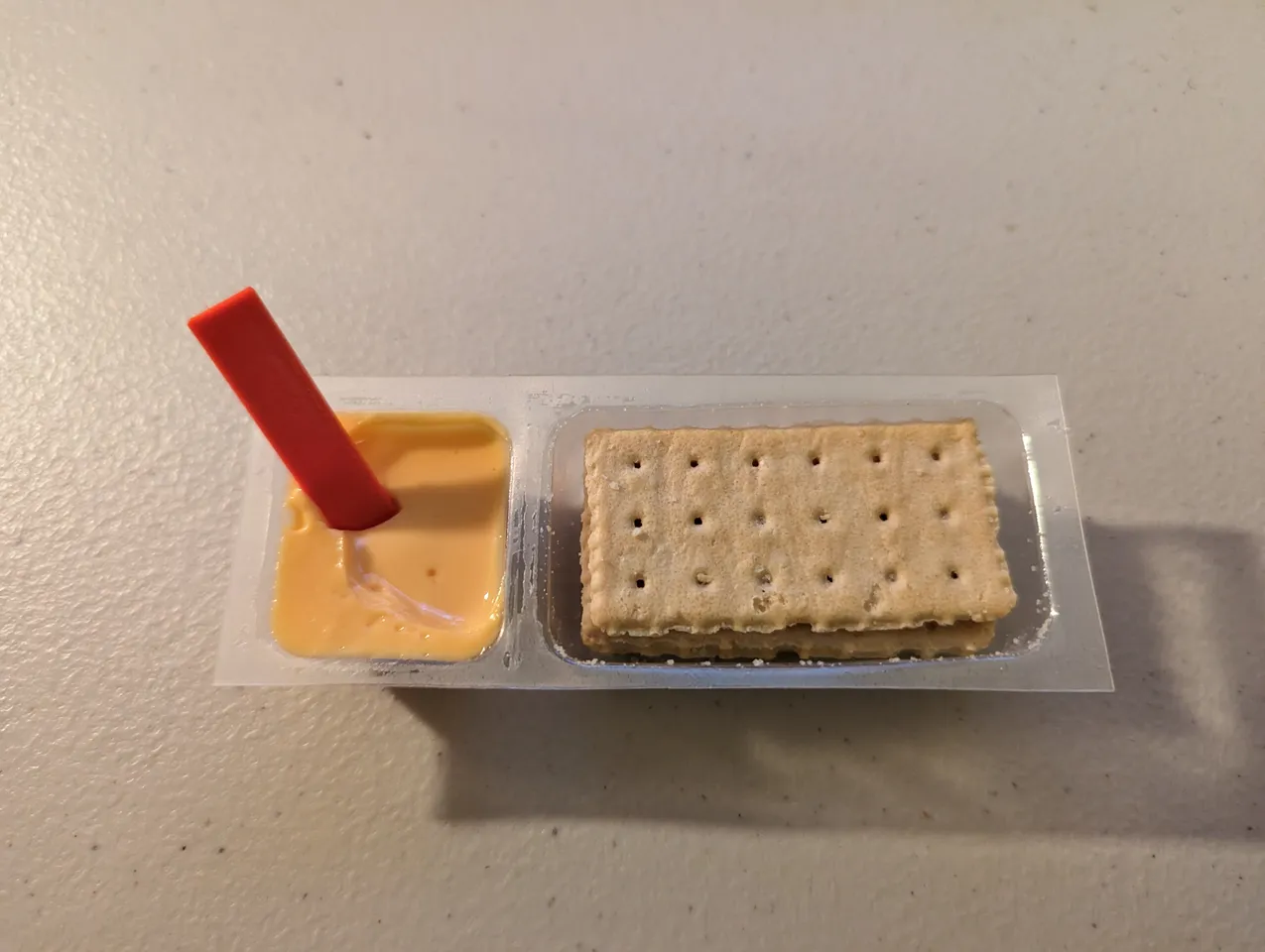 The snack with the little red stick