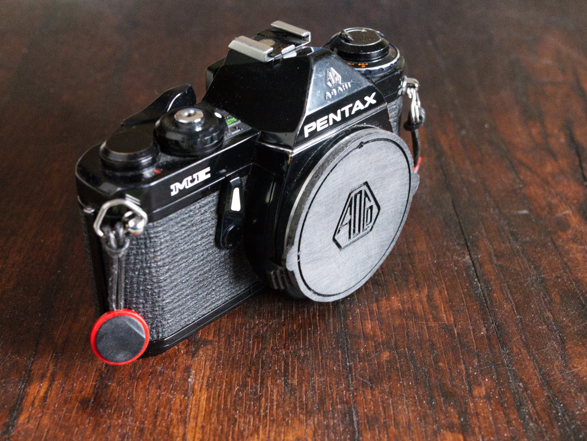 Pentax K body cap with/without the old Asahi Optical Co logotype.