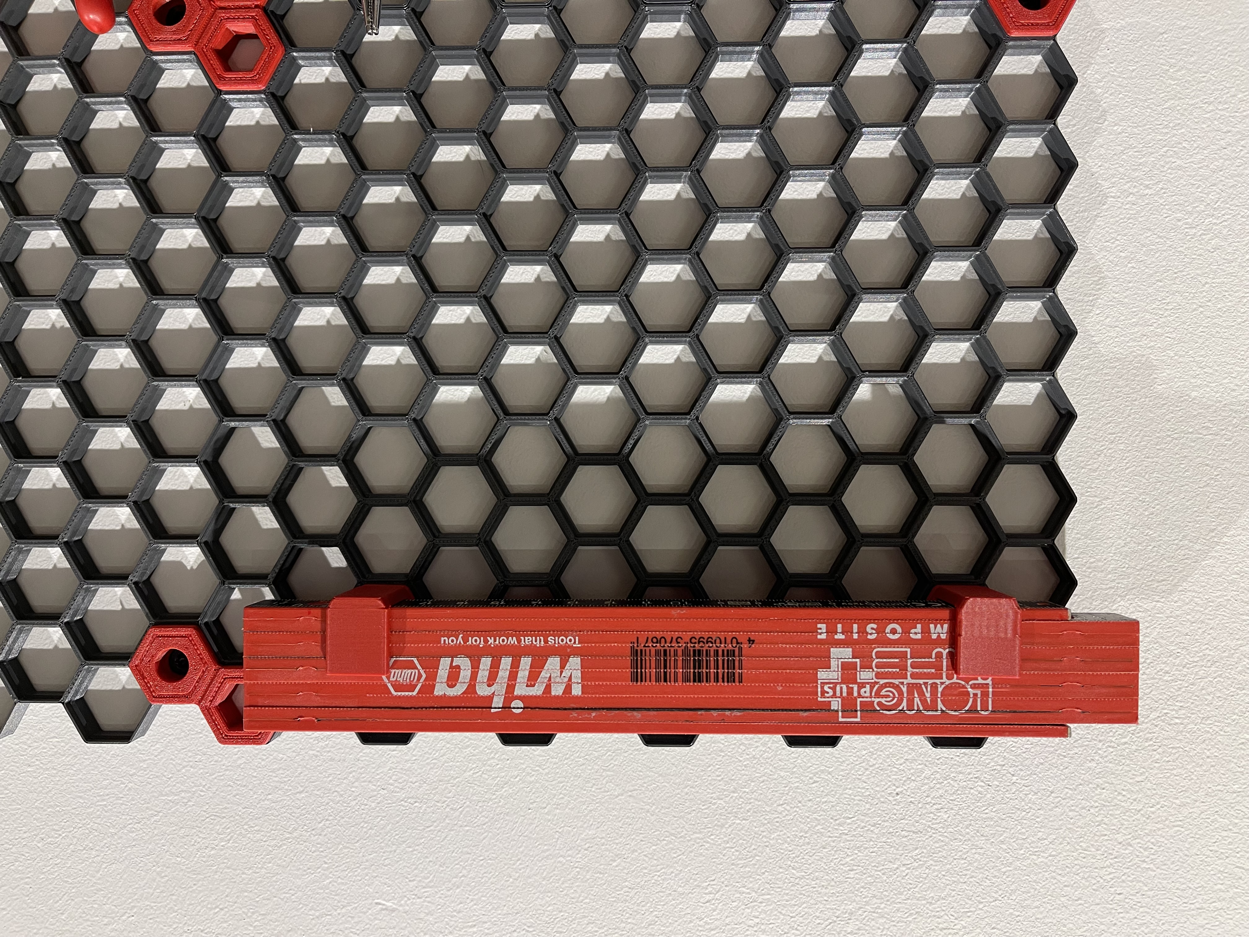 Folding ruler holder for honeycomb storage wall (HSW)