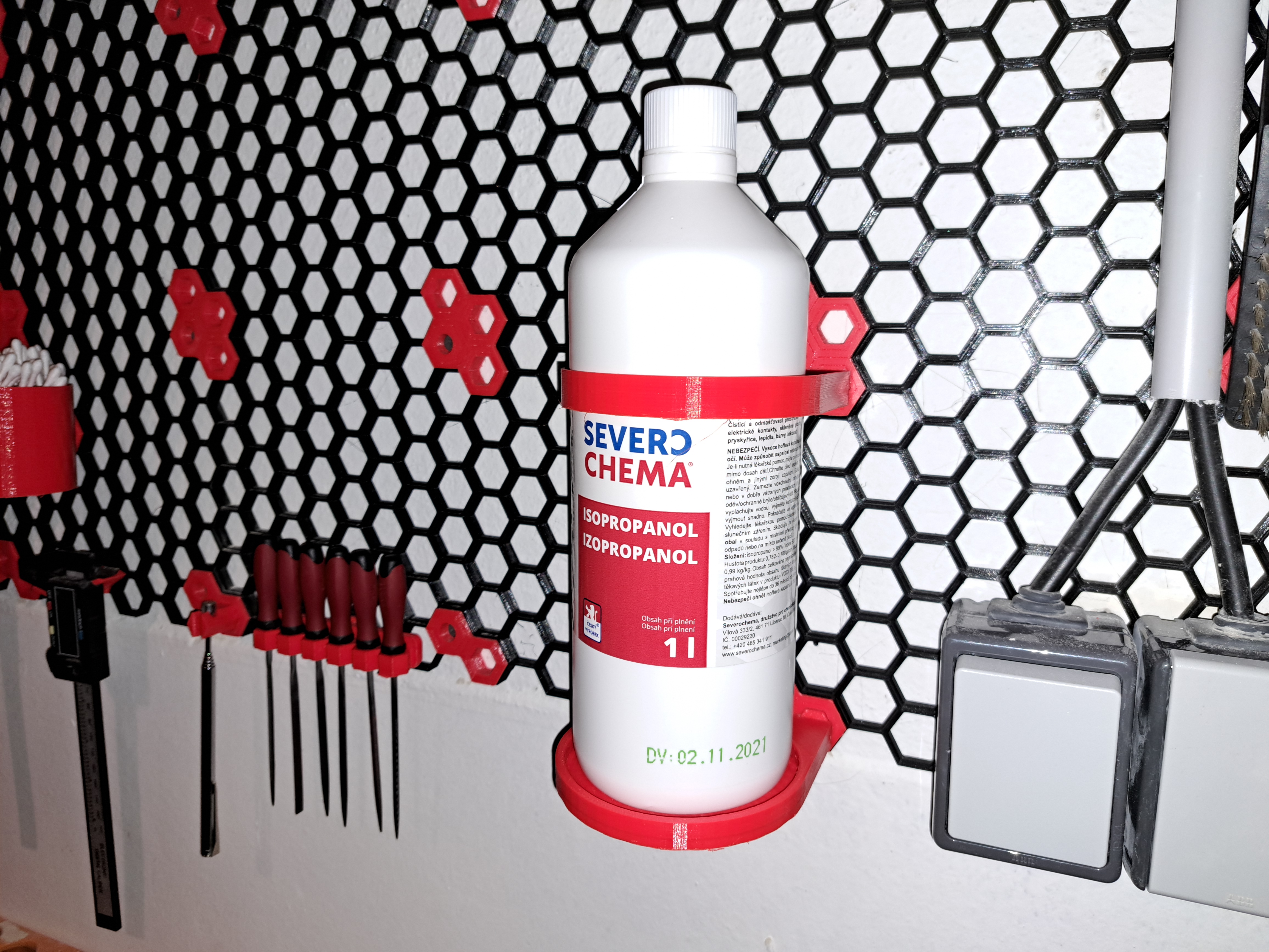 Isopropanol/bottle holder for honeycomb storage wall