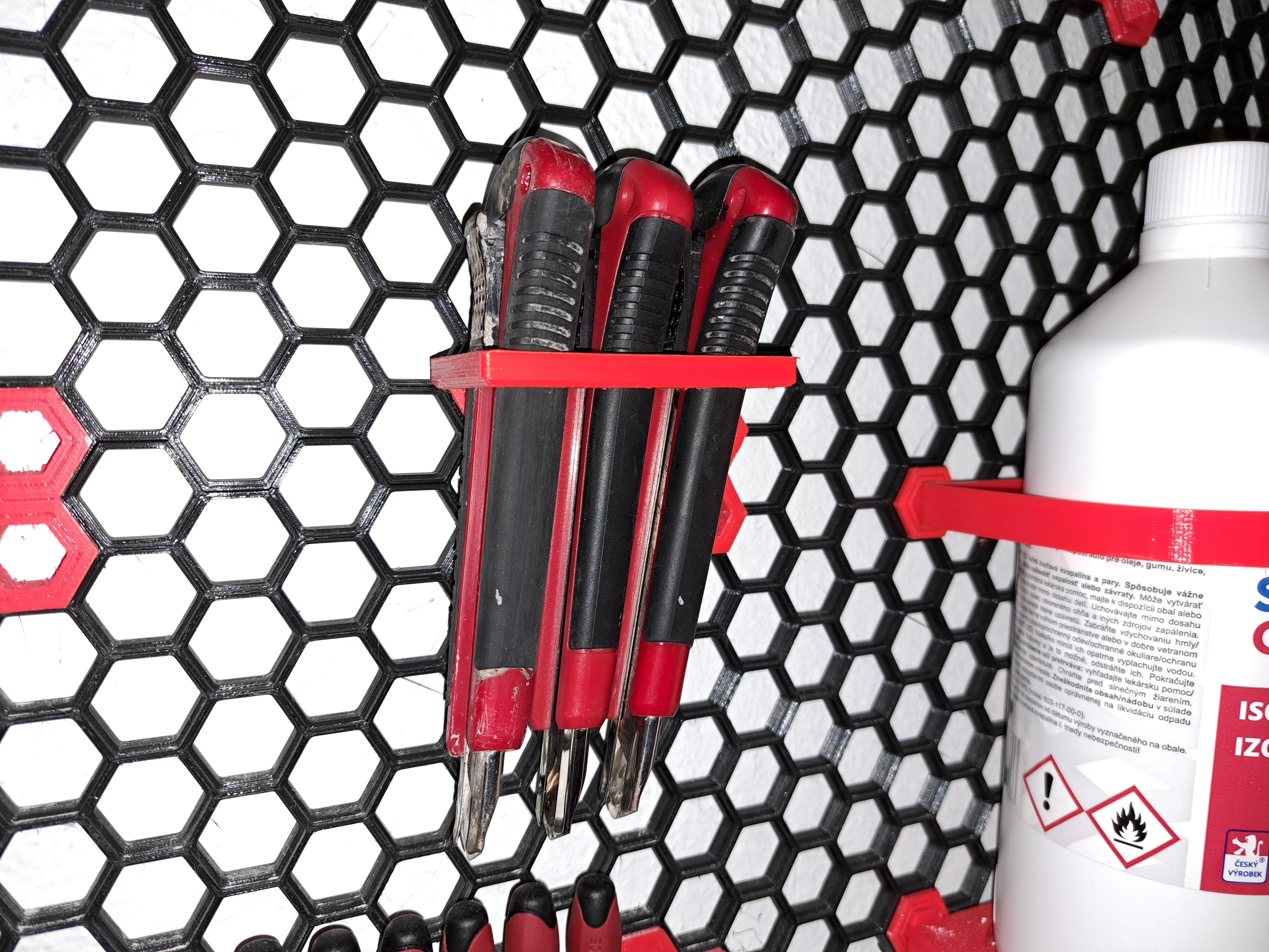 Carpet knife/half round file holder for honeycomb wall
