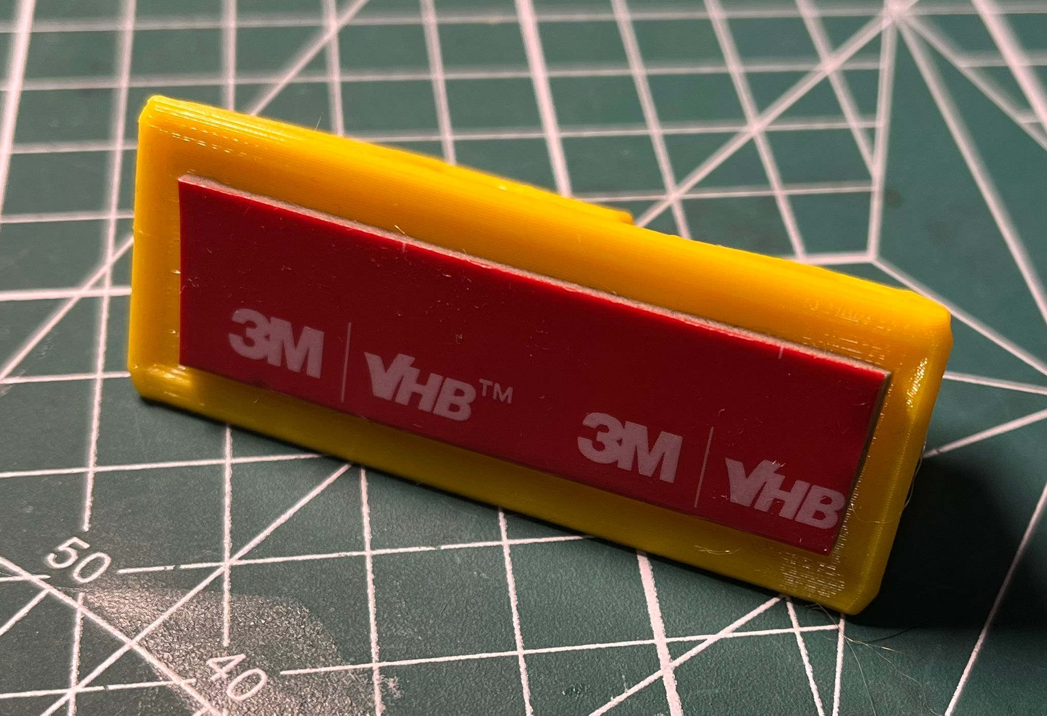Wall hook with groove for double sided tape