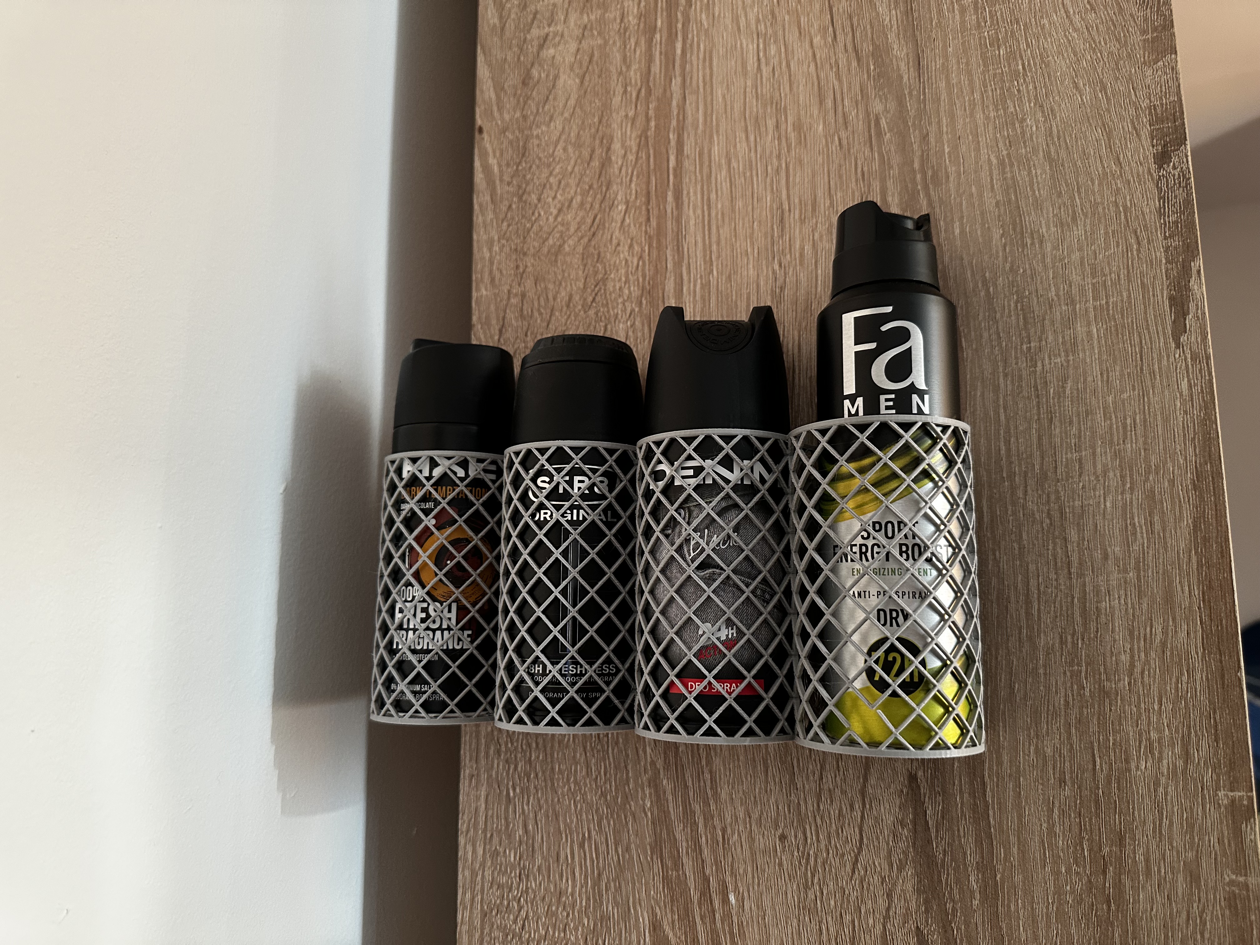 Wall mounted deodorant / can holder
