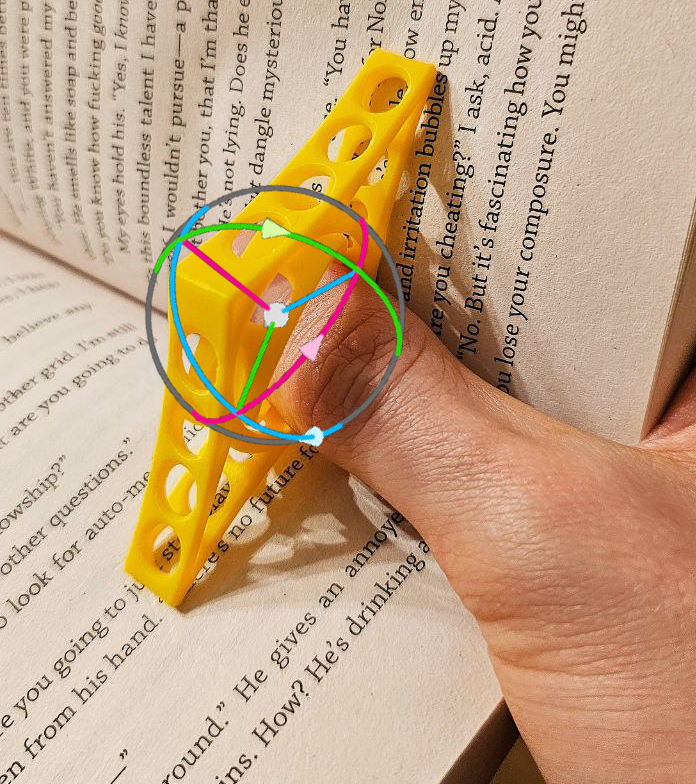 Book page spreader with ergonomic rotating ring. Print in place