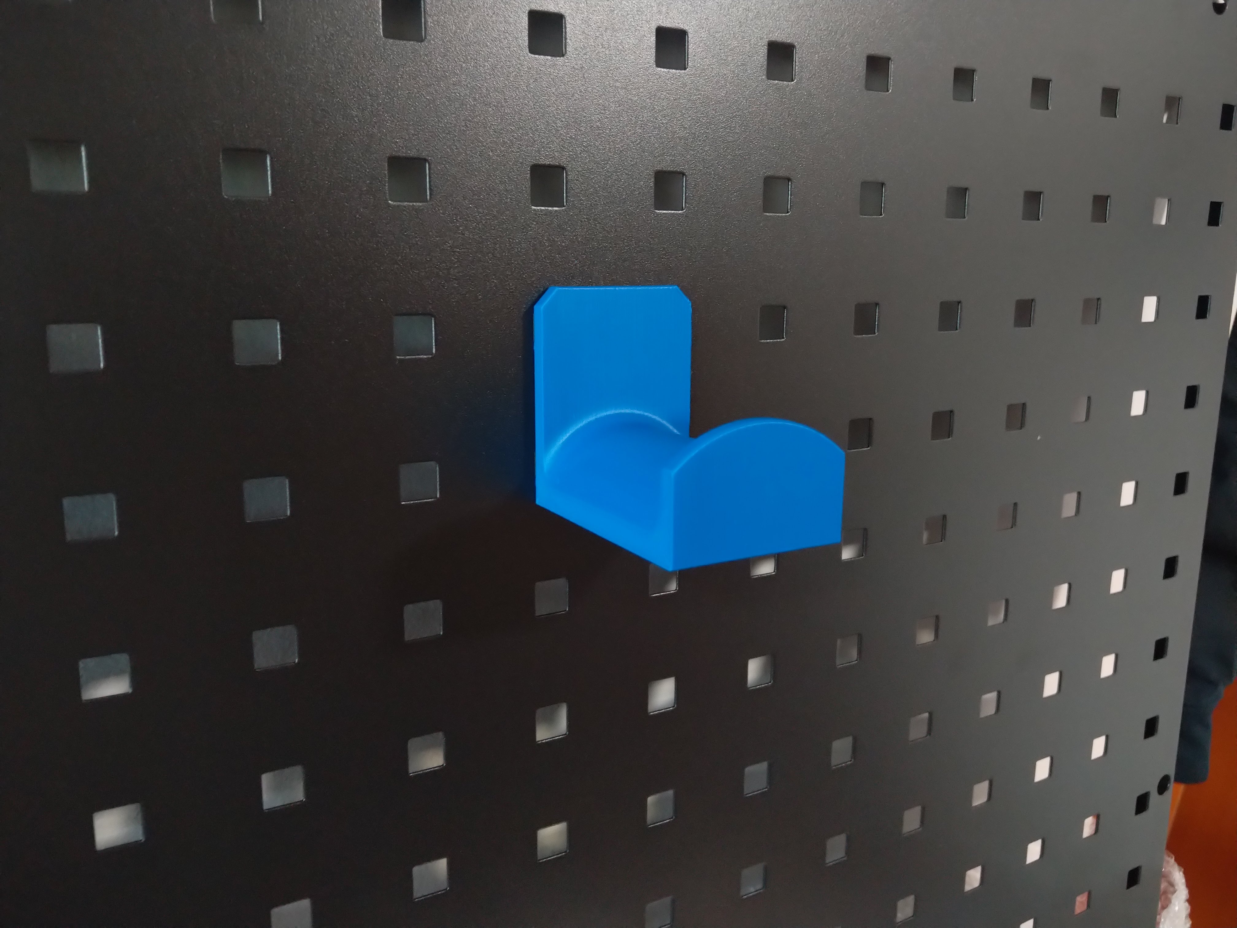 Headphone holder for perforated panel