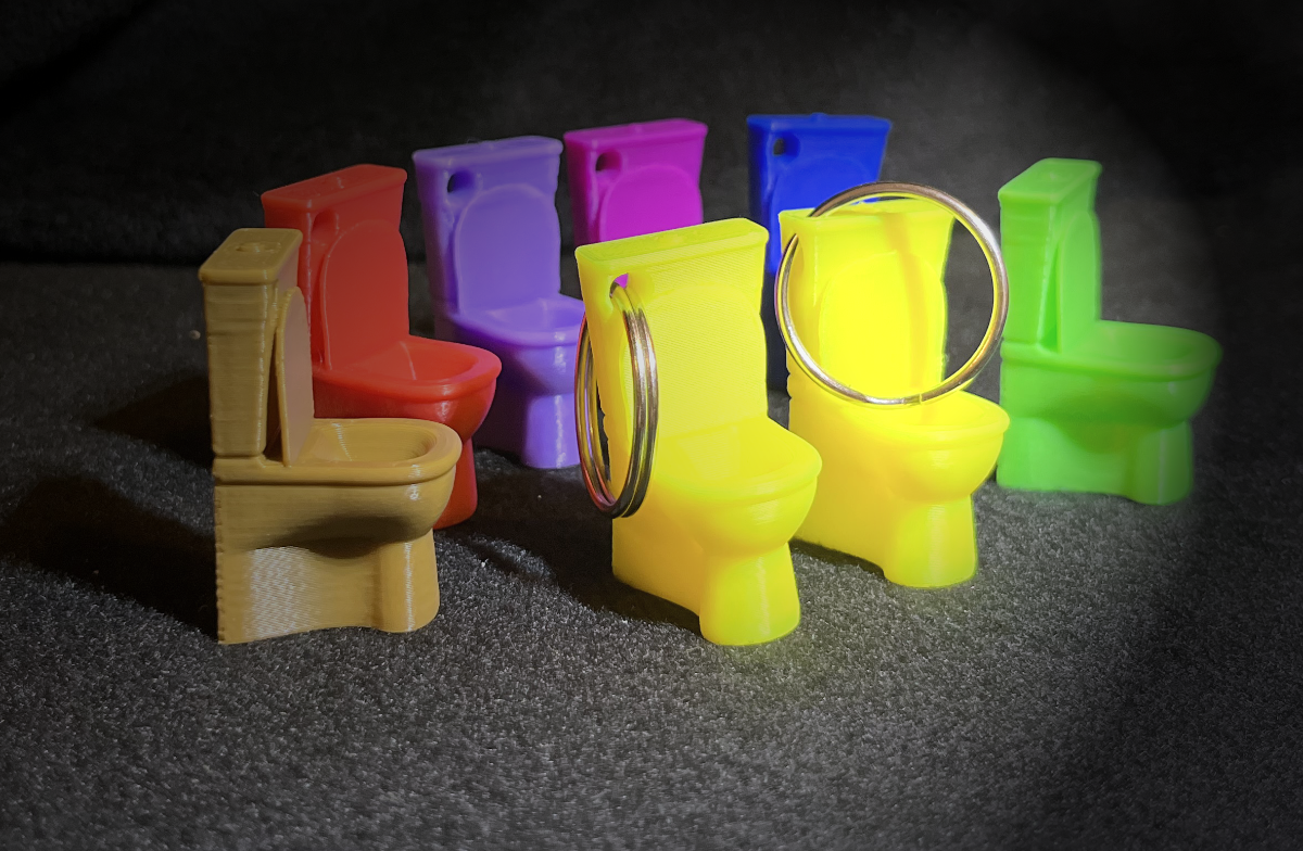 Key chain toilet whistle
