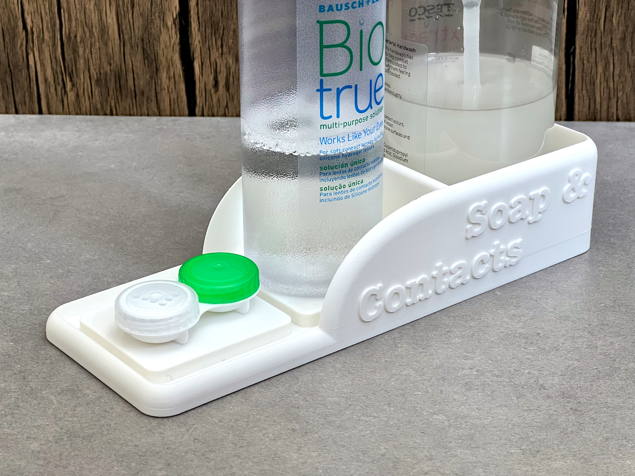 Bathroom organiser tray for a soap dispenser, contact lens liquid and case