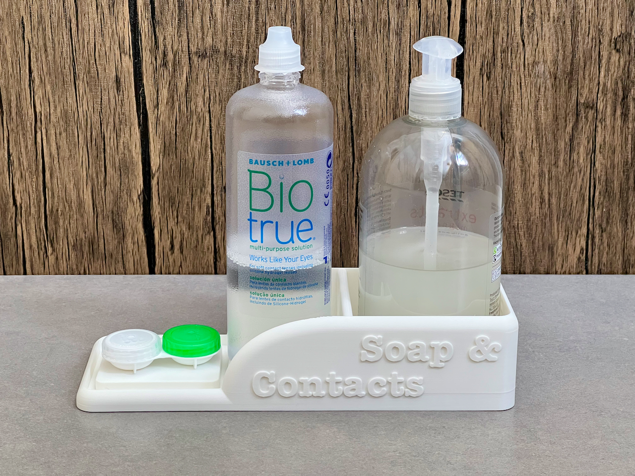 Bathroom organiser tray for a soap dispenser, contact lens liquid and ...