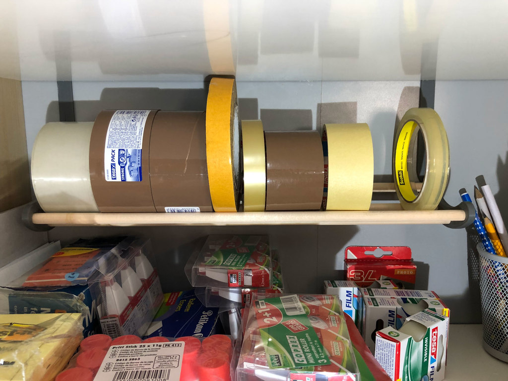 Tape holder hooked to the shelf