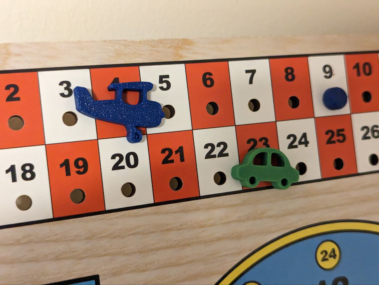 Pegs for a calendar: car, airplane, dot