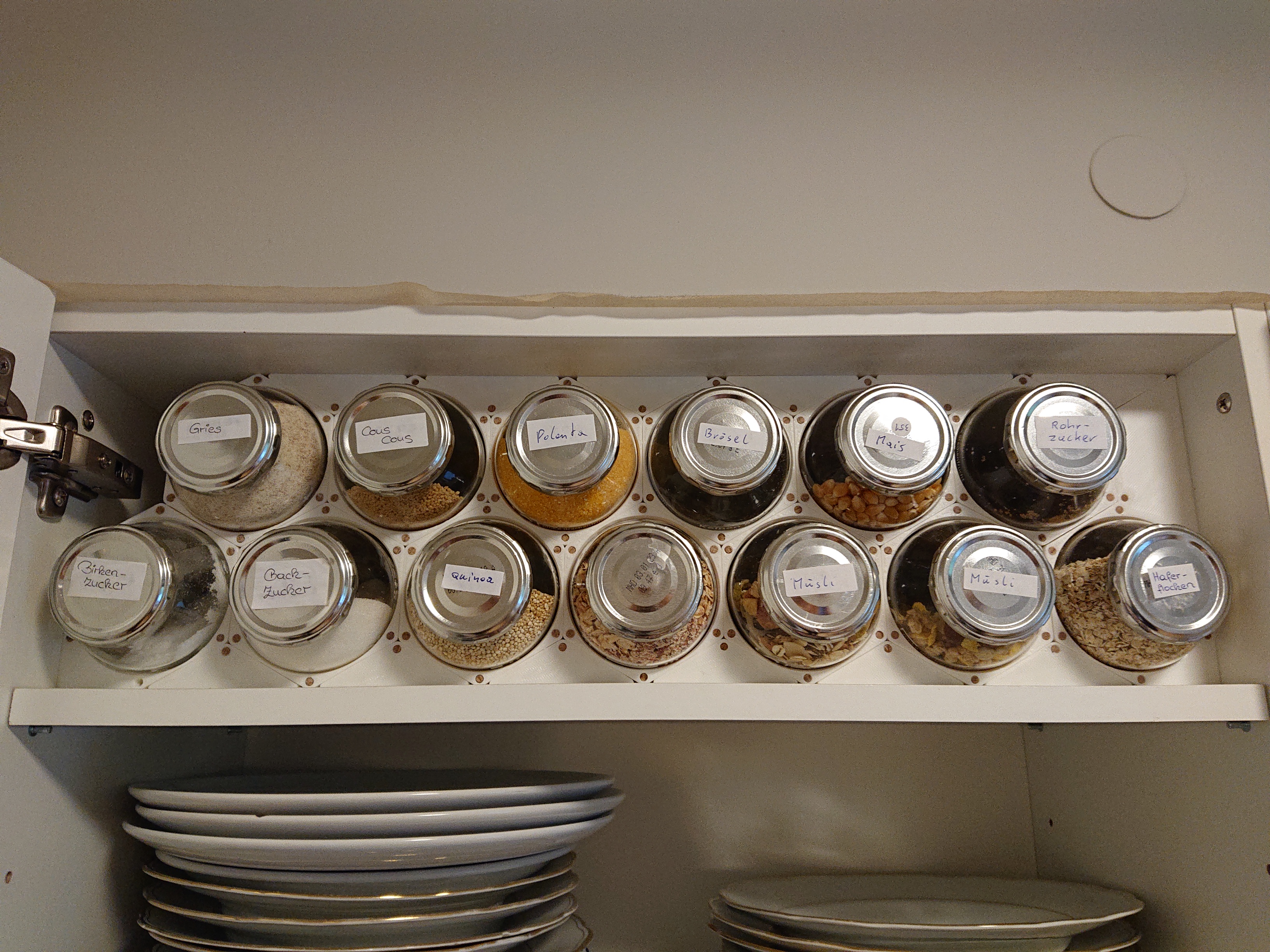 Modular kitchen storage using upcycled glass bottles.