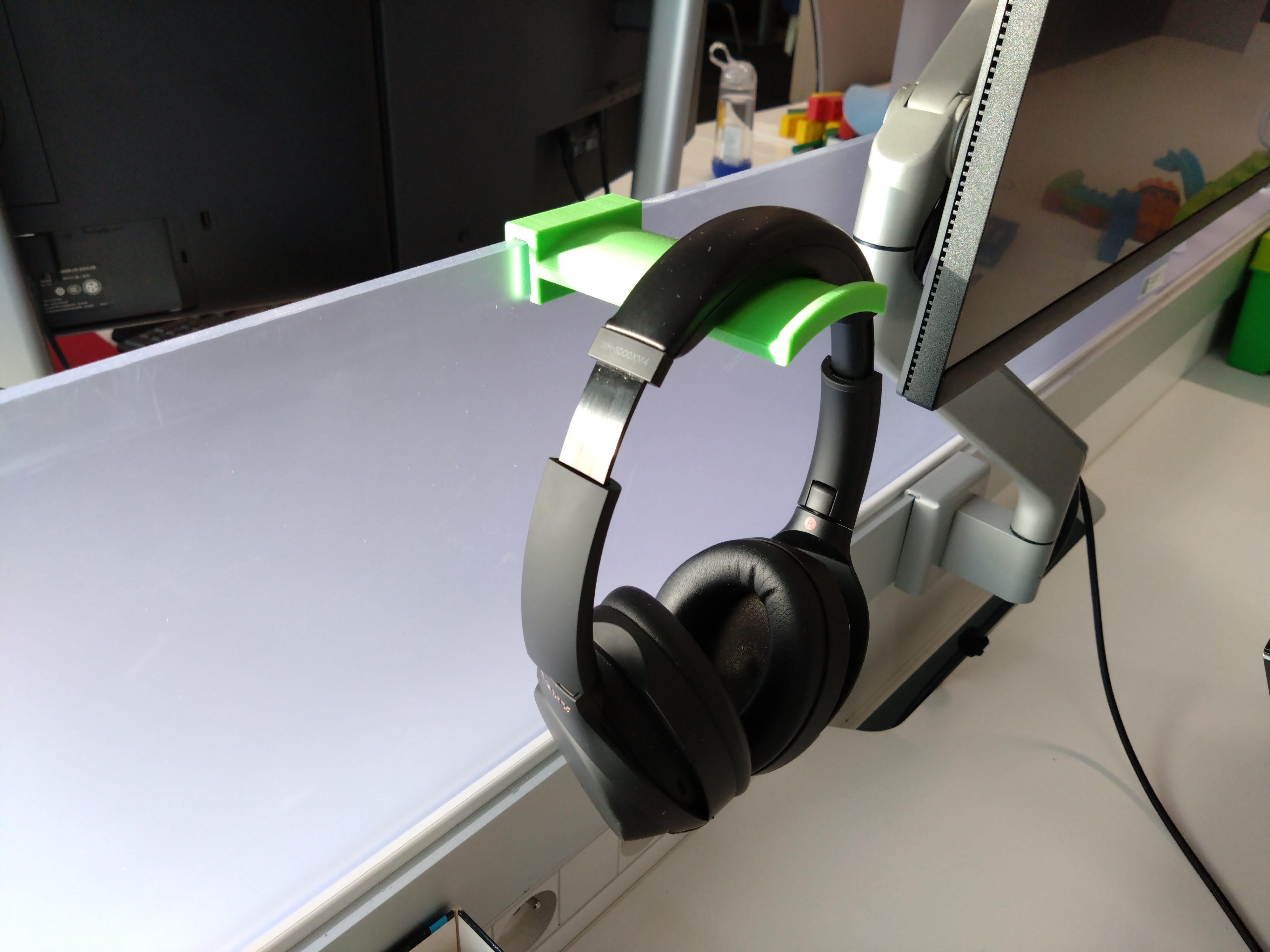 Parametric headphone holder for clamping on office space divider by
