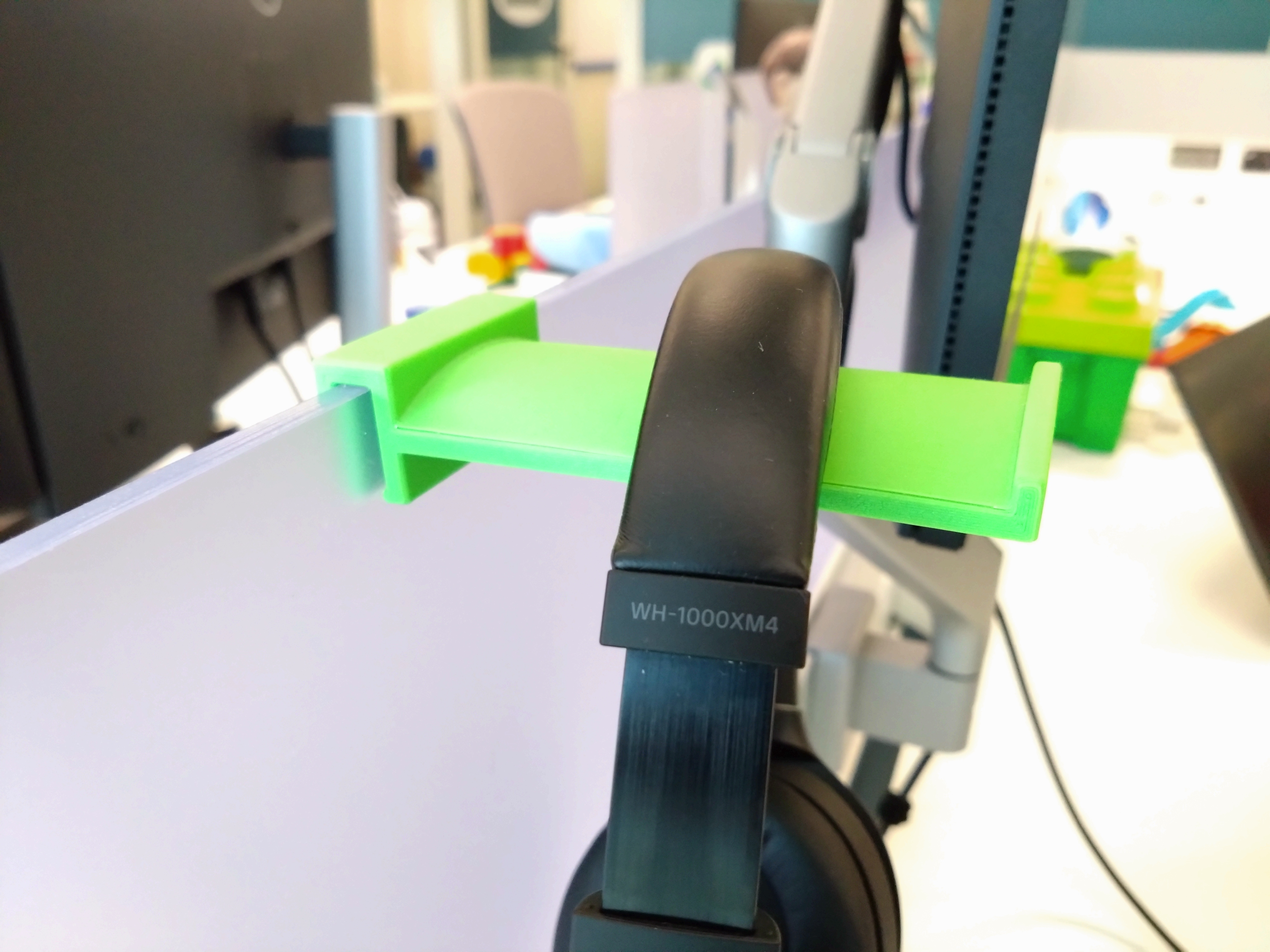 Parametric headphone holder for clamping on office space divider
