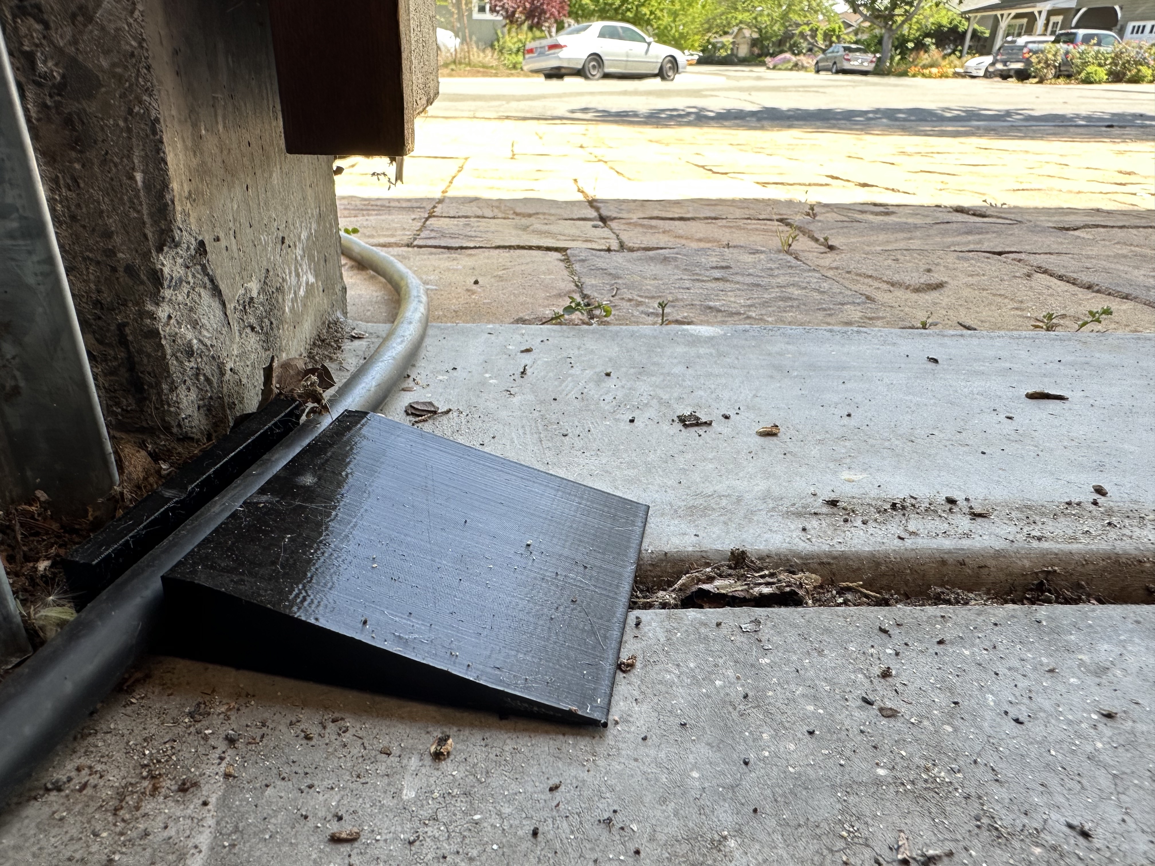 Garage door cable protector for Tesla UMC