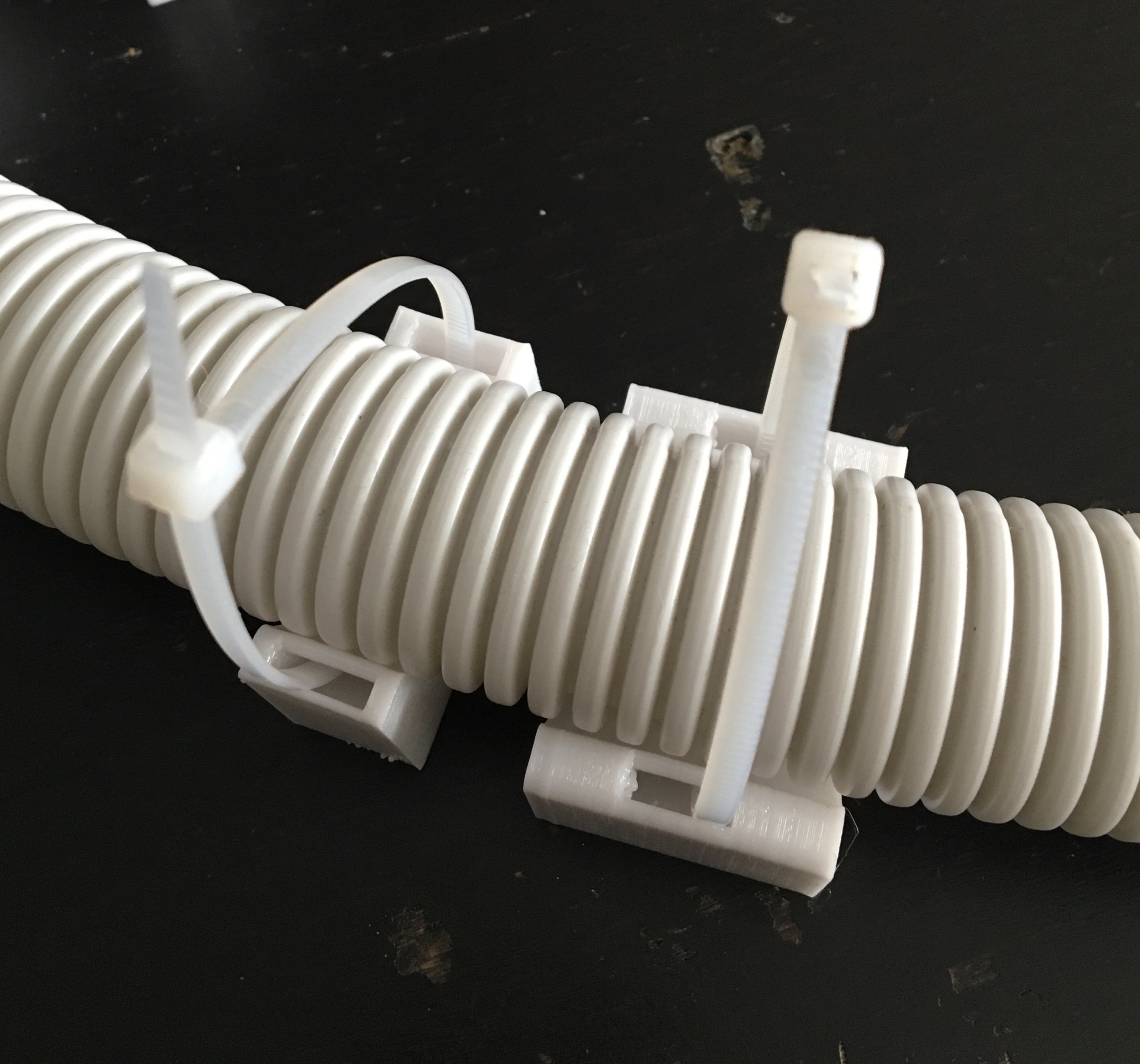 Cable holder for attaching corrugated tubing to the wall by santiniki