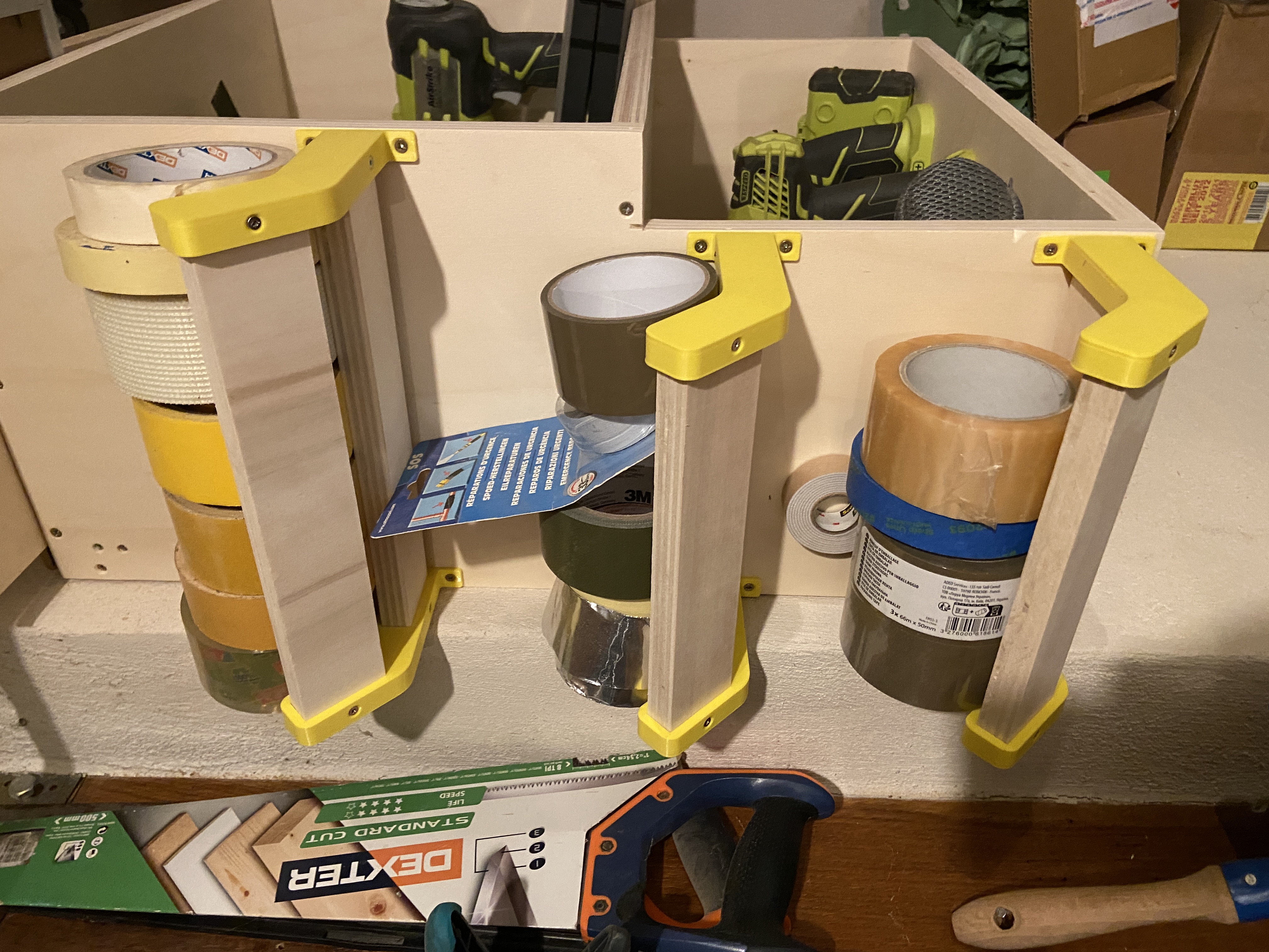Brackets for a shelf to store tape rolls