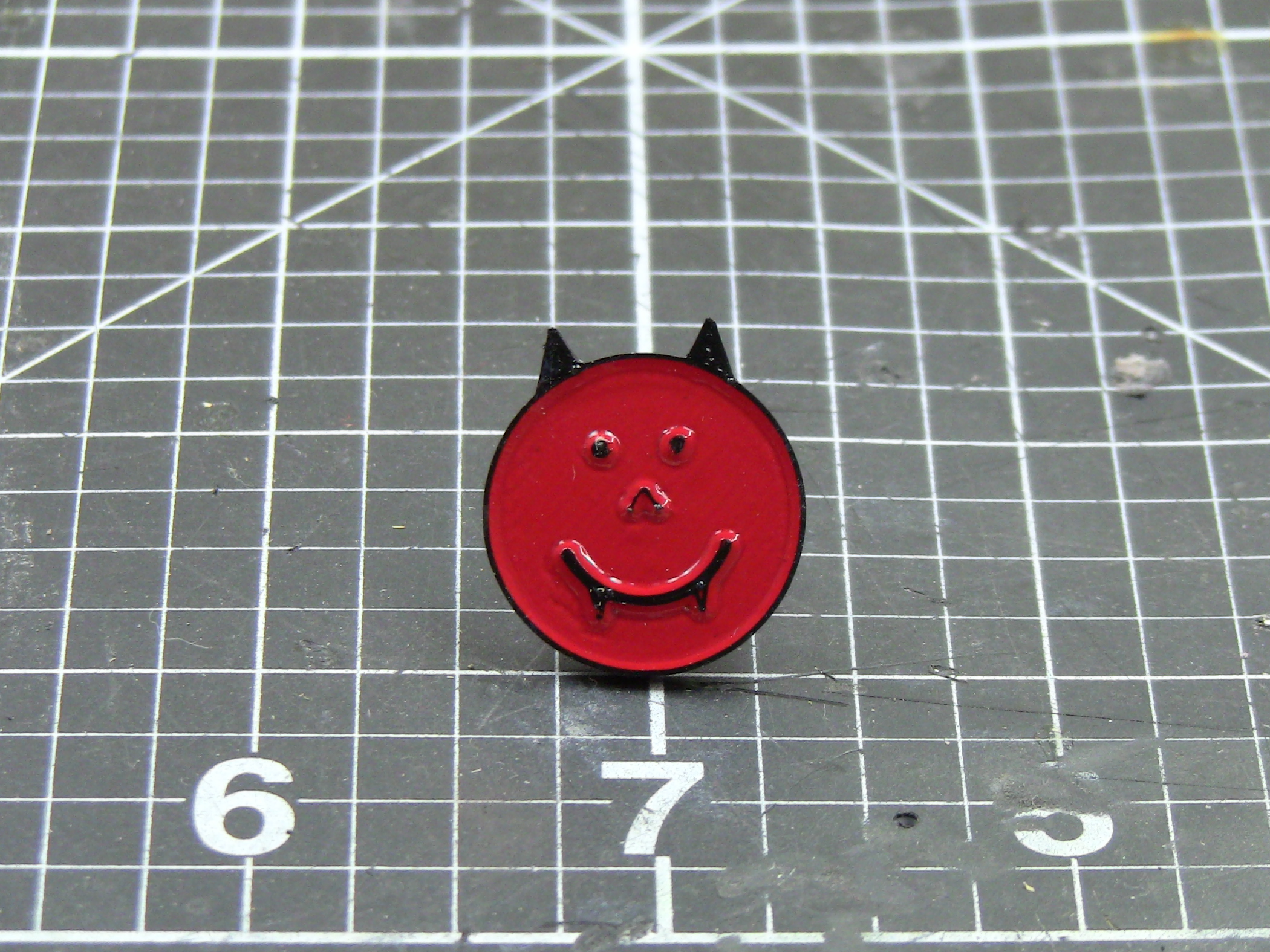 Happy demon head enamel pin