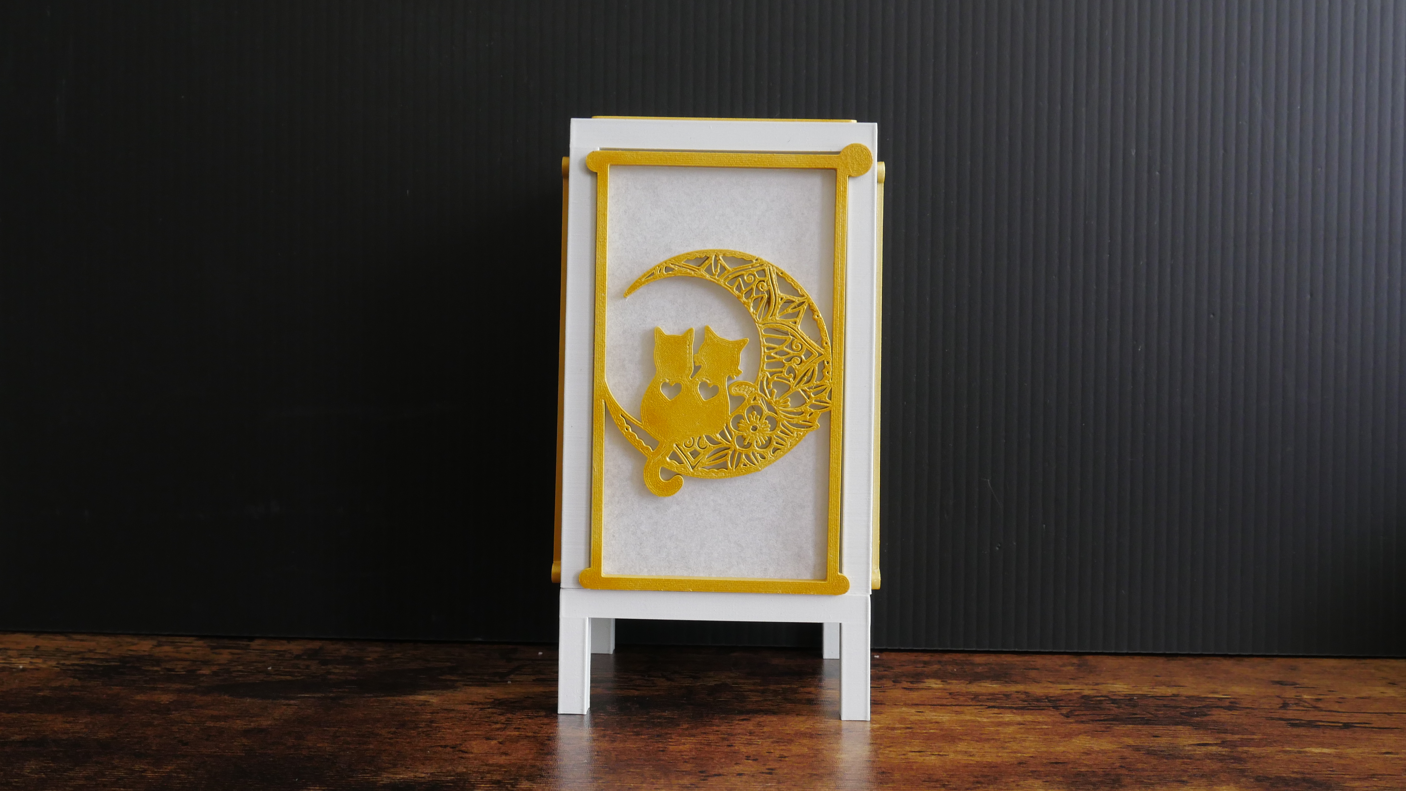 Lamp featuring panels with a cat design