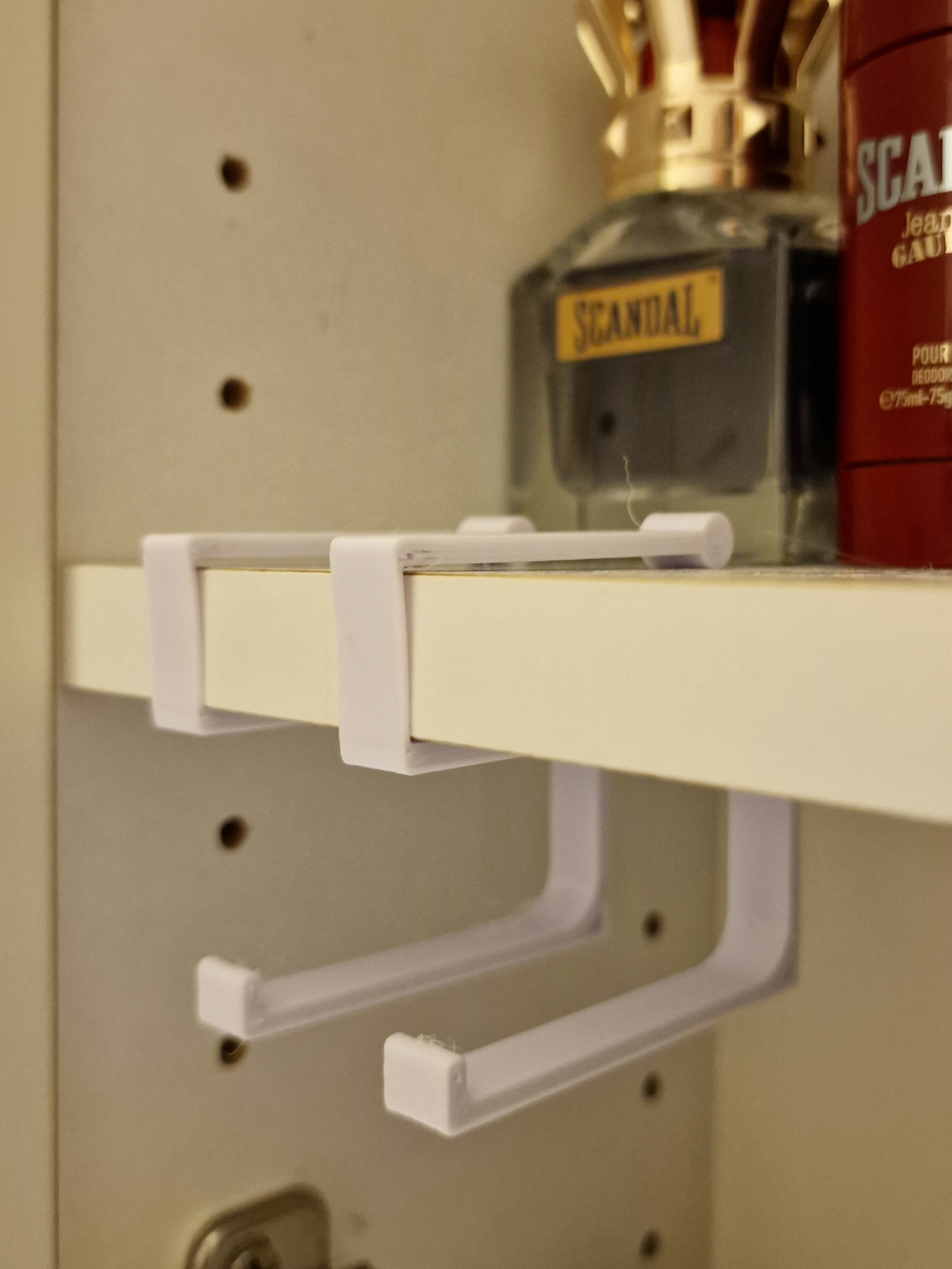 Bathroom cabinet shelf mounted holder