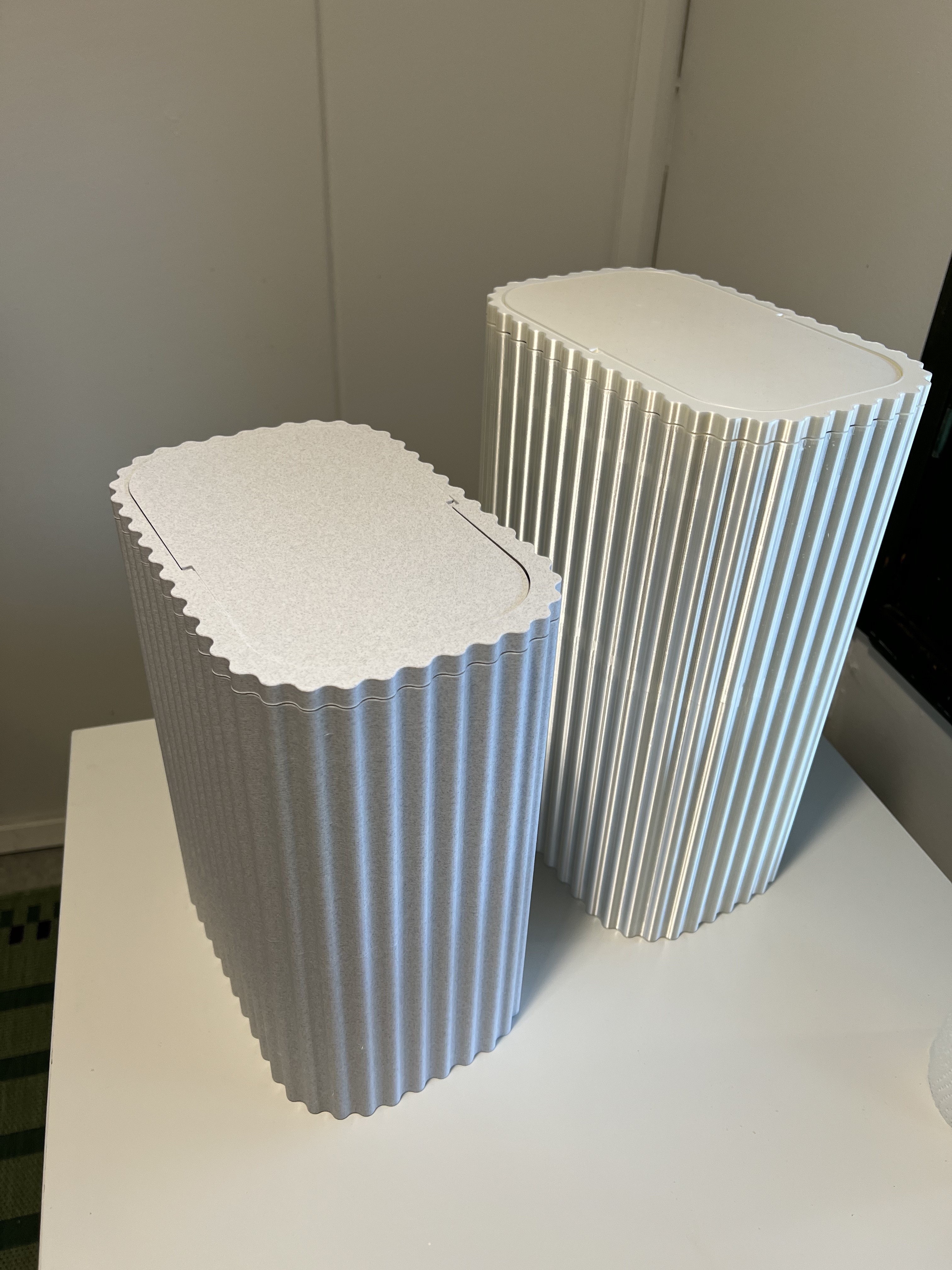 Trash can with hinged lid