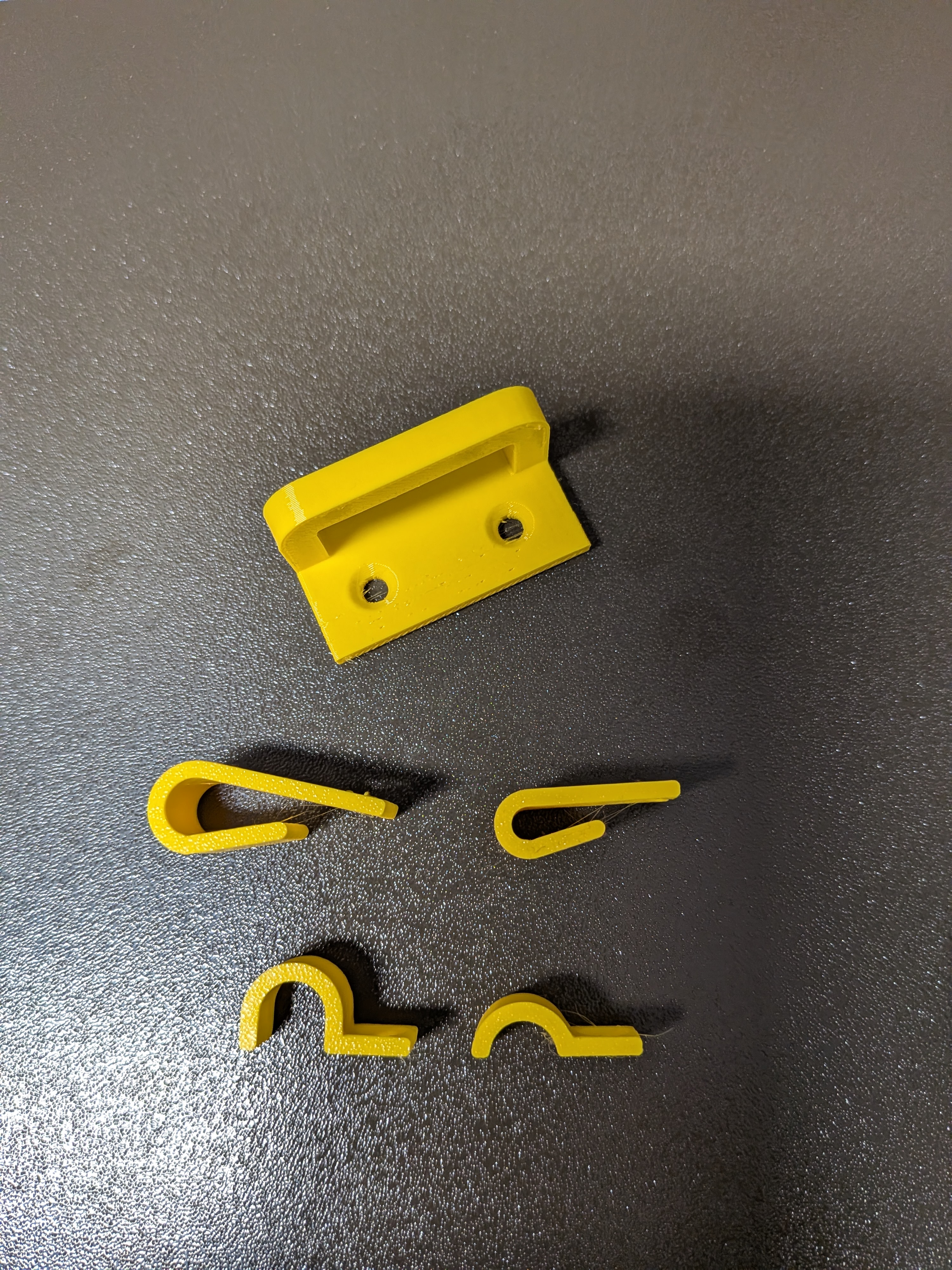 Cable clips, cable hooks and a simple bracket to attach cables with zip ties or velcro