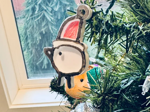 Santa canary bird and sled ornament