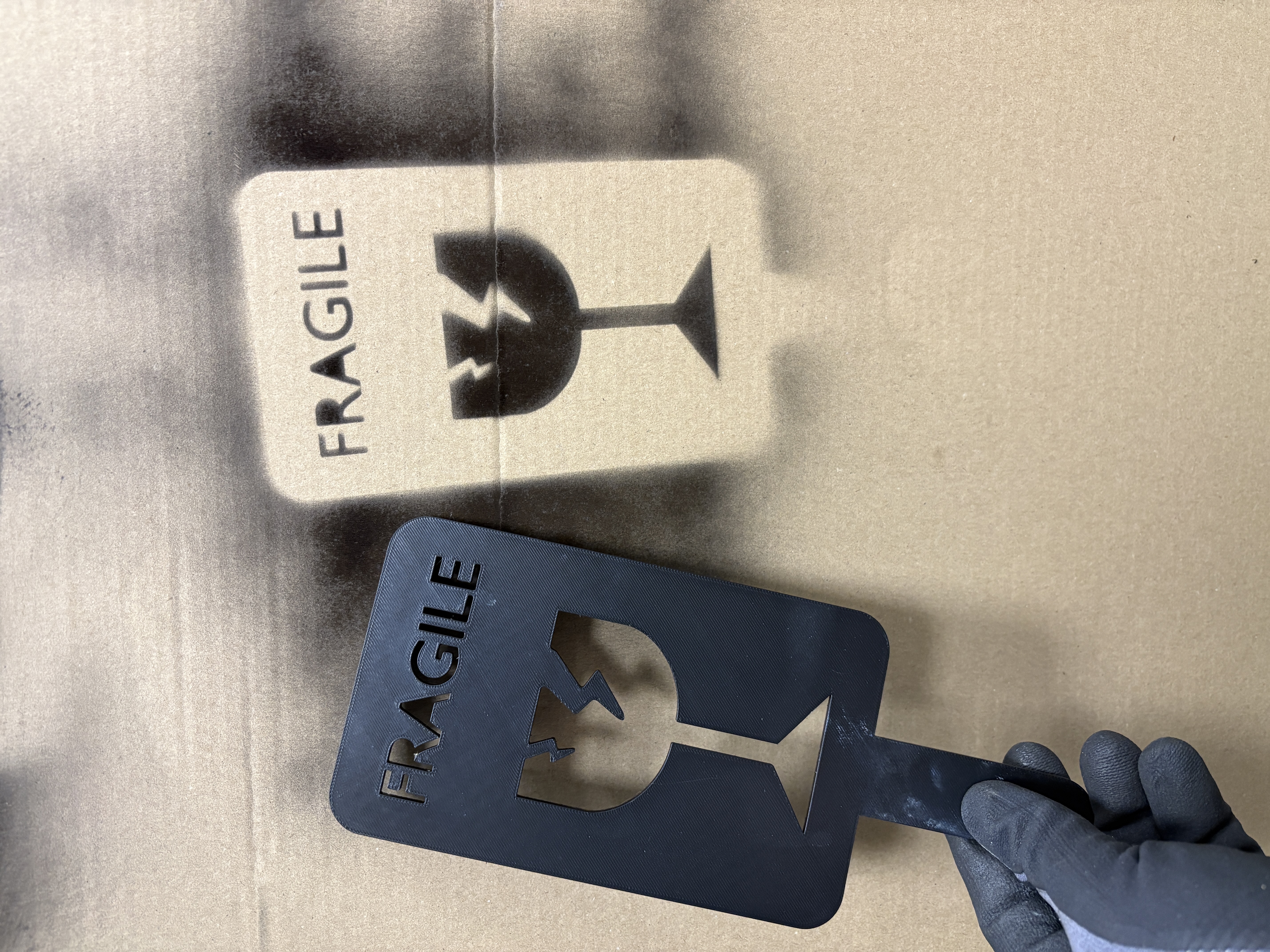 Fragile stamp for spray painting on packages
