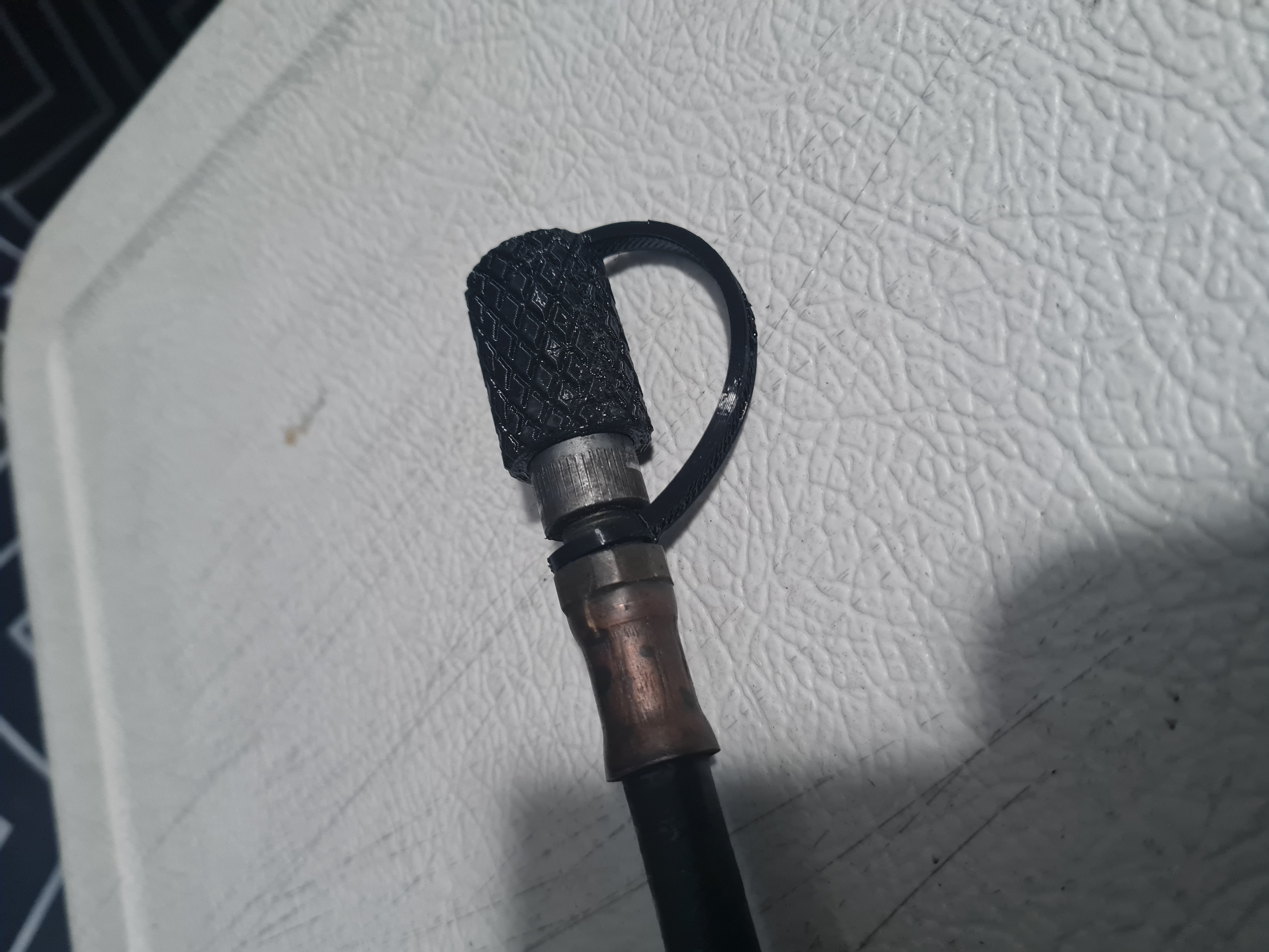 Vad Che's grease gun cap with a strap