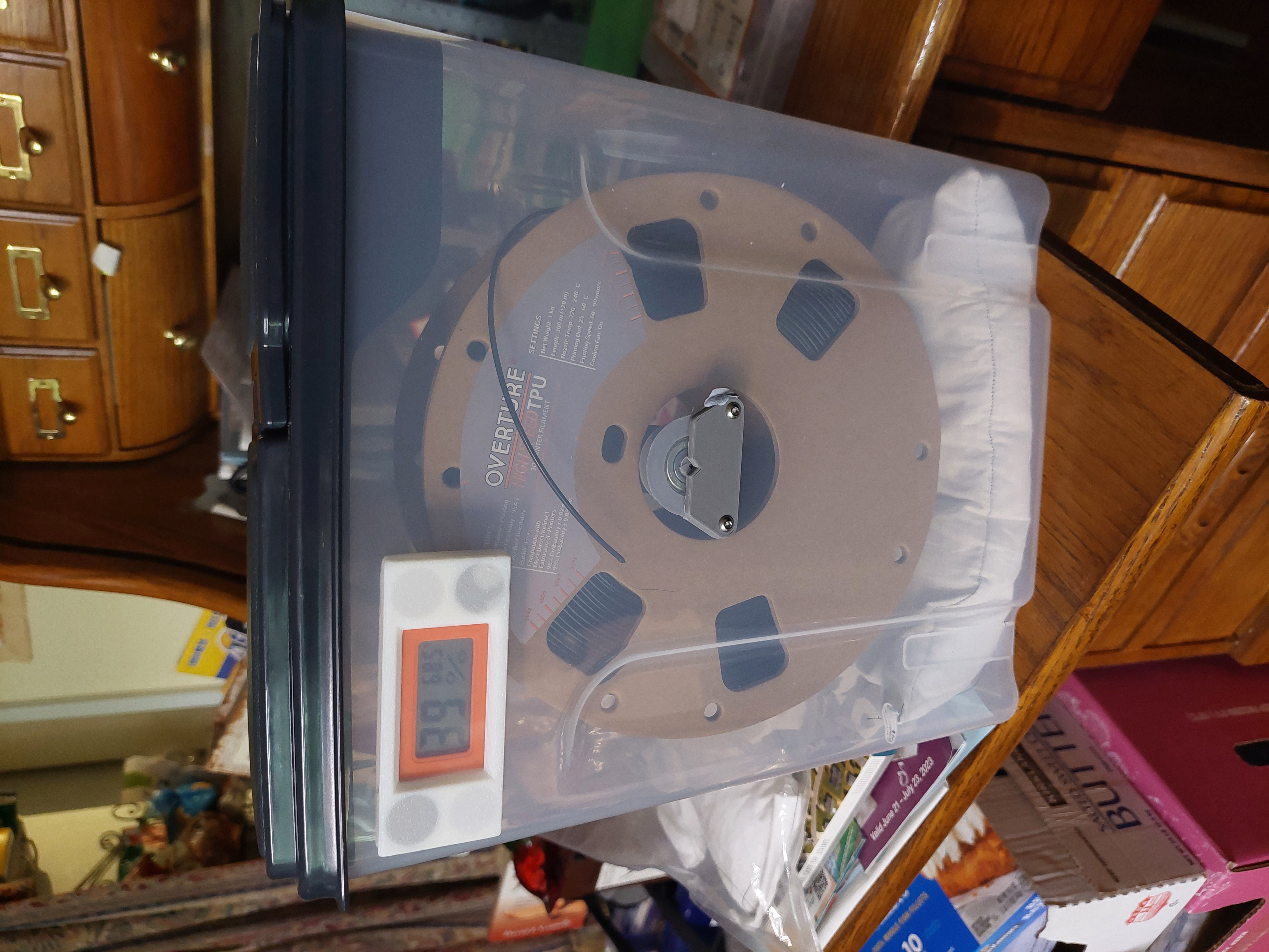 Cereal box filament roller with 608 bearings.