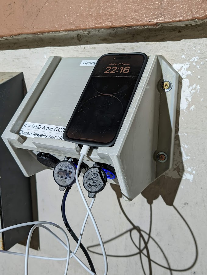 Public smartphone charging station, wall mounted, for 12/24V automotive sockets