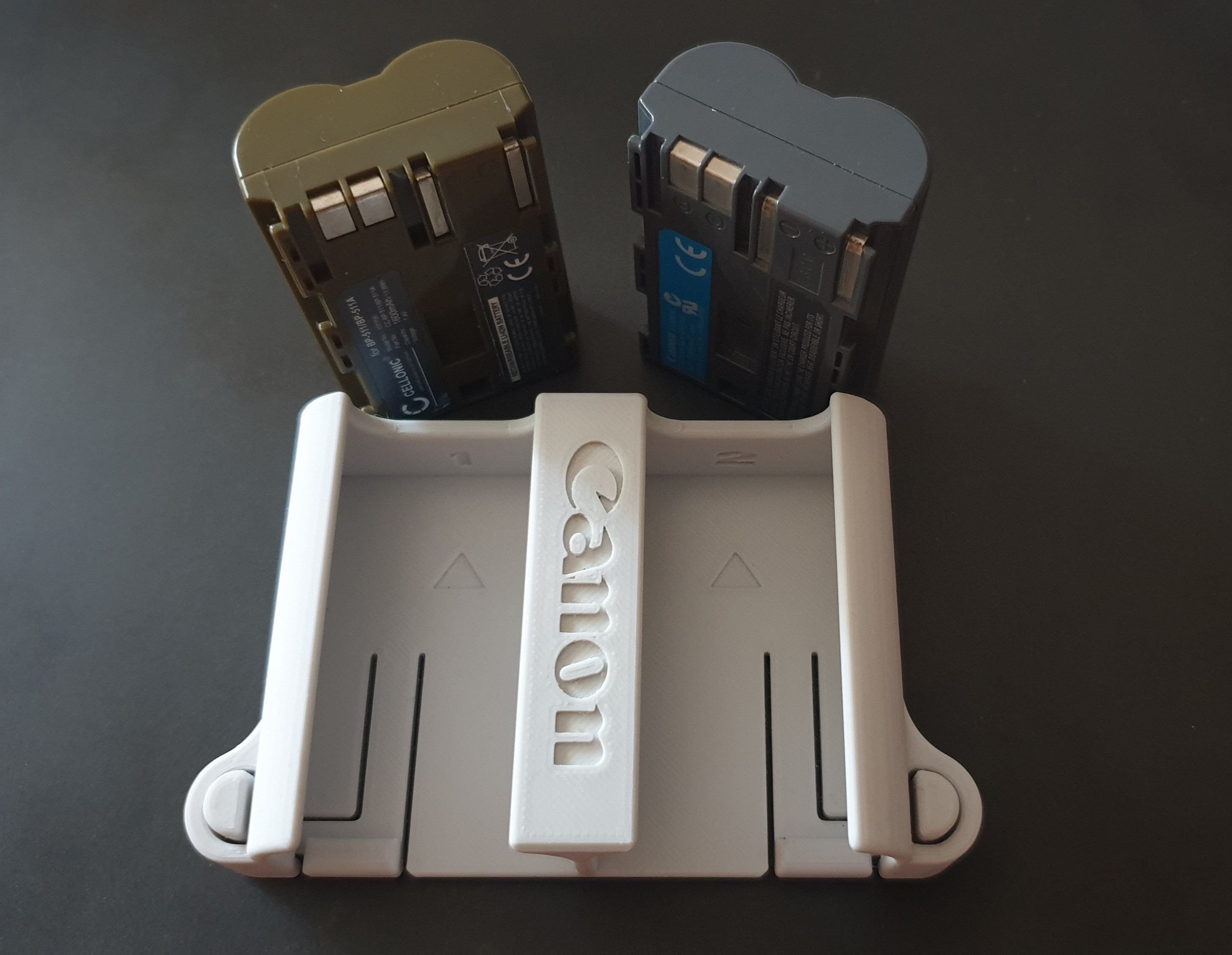 Portabaterías doble para BP-511 con pulsadores de liberación. Double battery holder for BP-511 with release buttons.