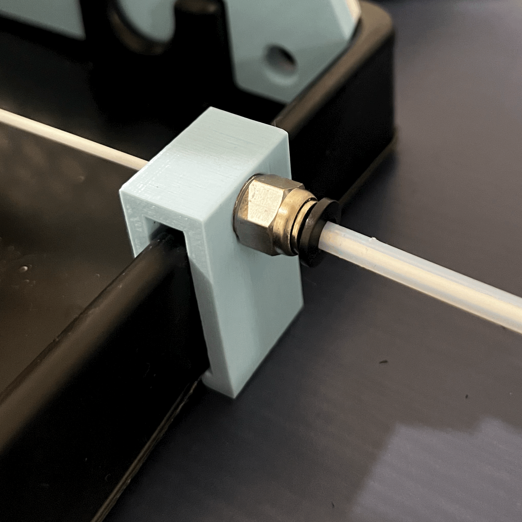 PTFE spoolholder feed clip with stopper