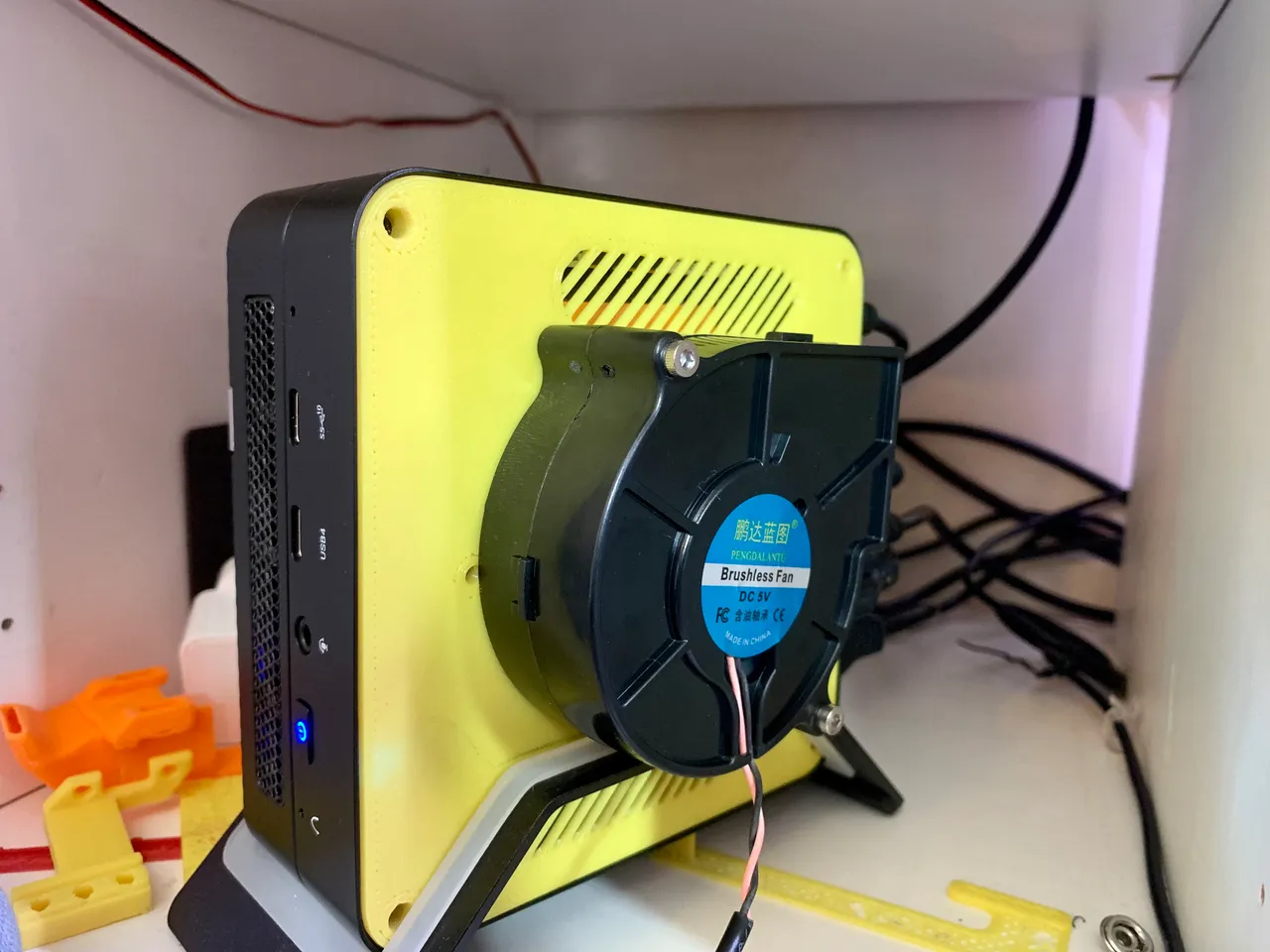 Minisforum UM690 case bottom with fan and vent cutouts. (Fusion