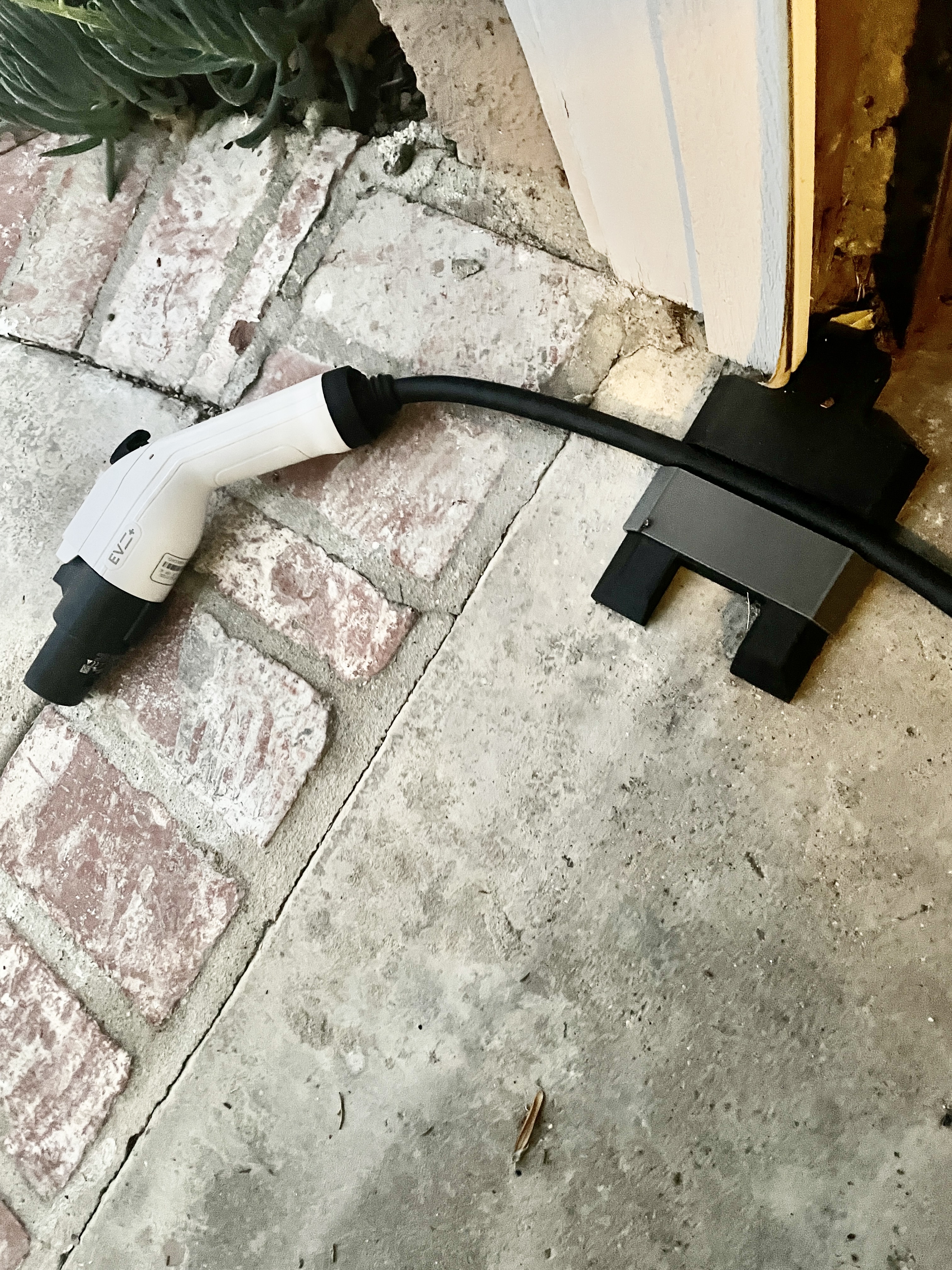 Underdoor garage door cable pass-thru