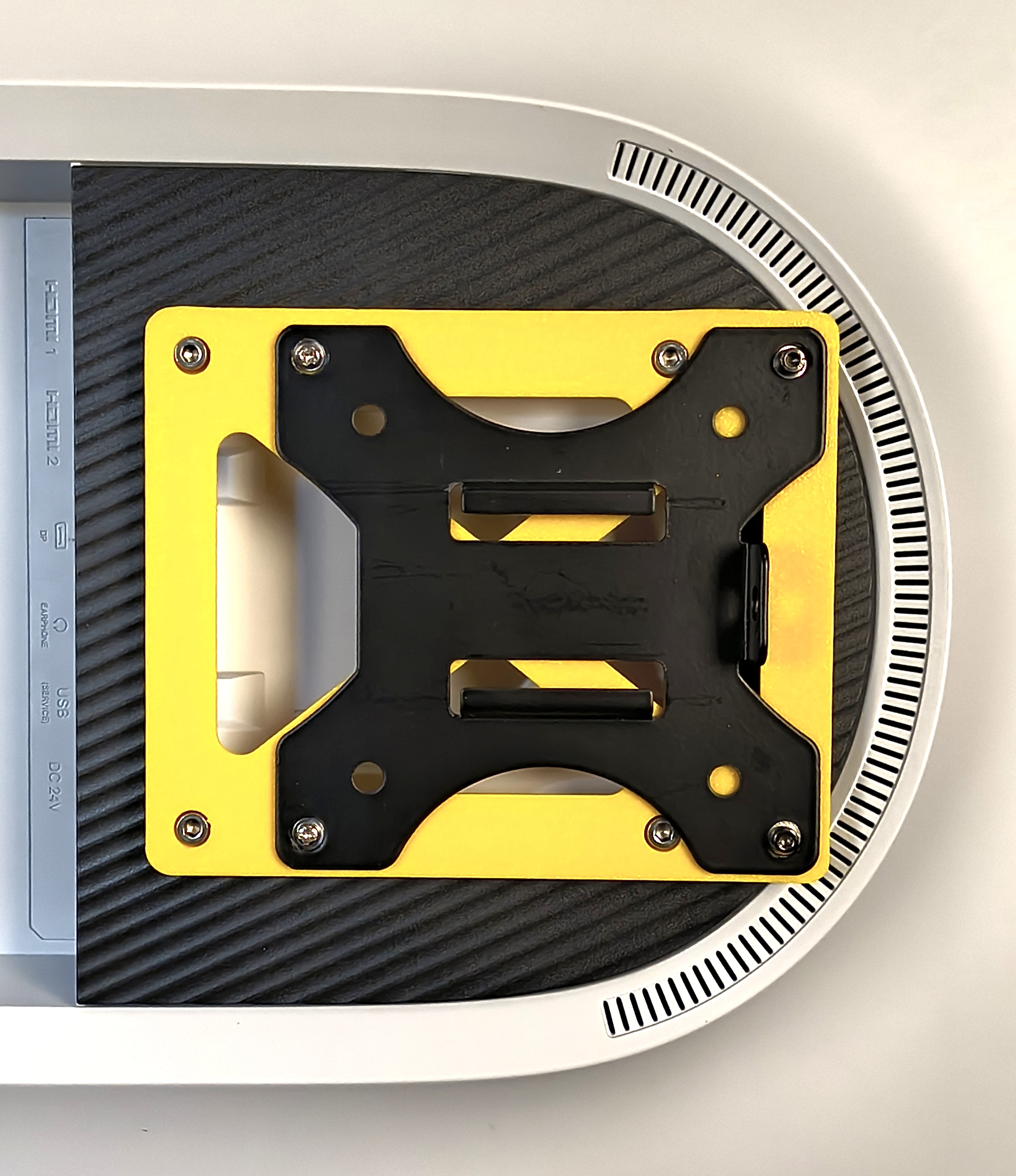 VESA 100x100 adapter to shift the monitor by 25mm.