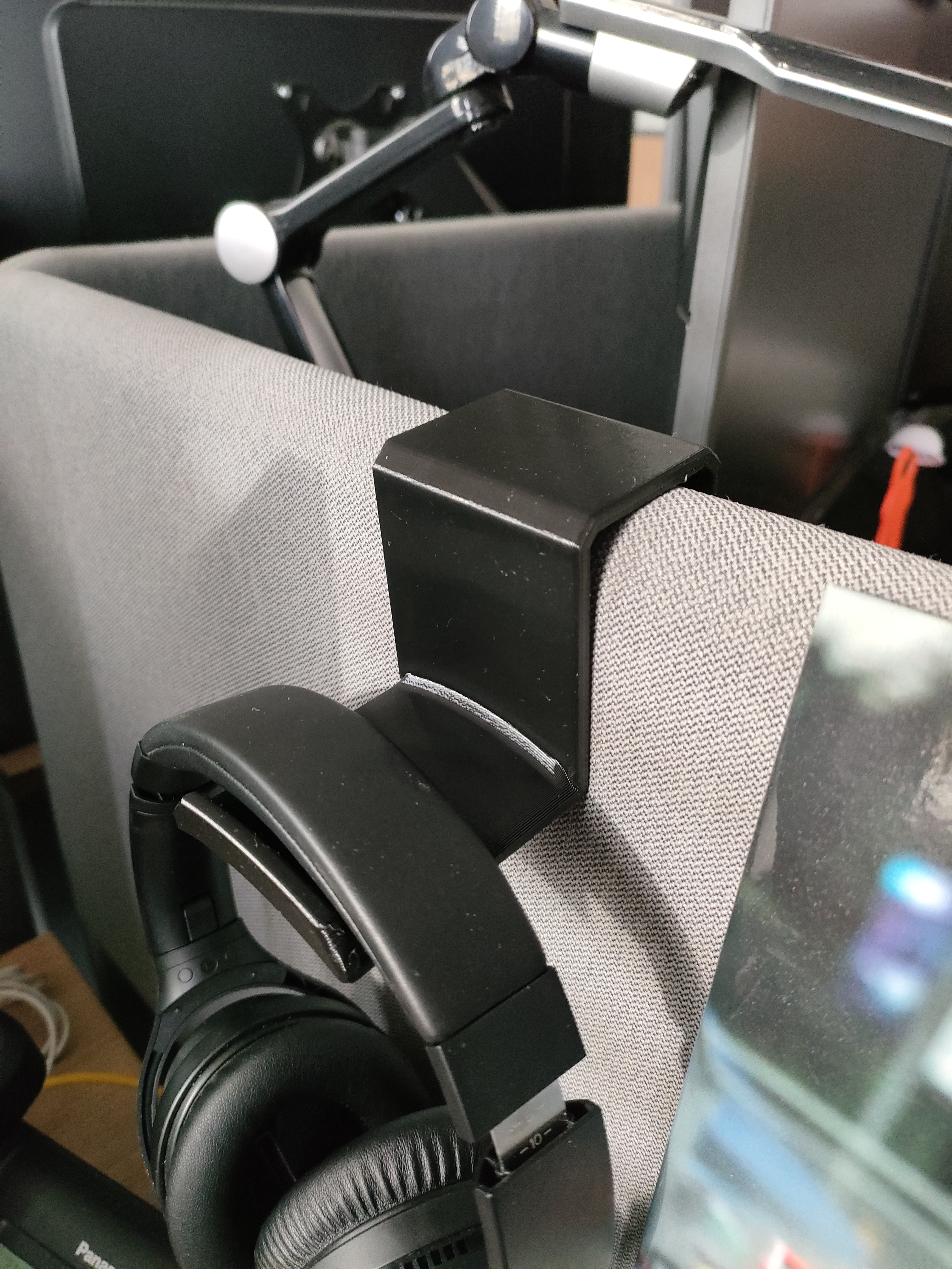 Headphone holder mounted on cubicle divider