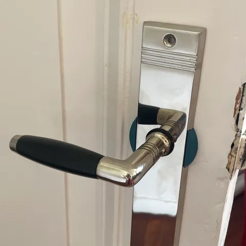 Door handle blind shield blanking plate