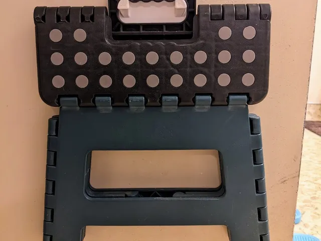 Wall hanger for fold-up step ladders.